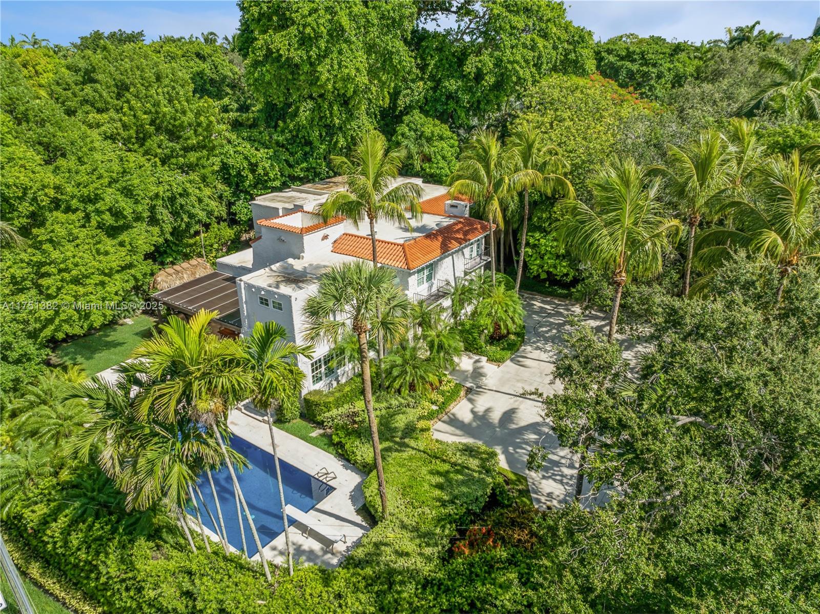 Best of two worlds: stunningly 1926 large traditional home --with  totally renovated interior in south Grove! Brand new roof and a home spanning 6,442 square feet of immaculate living space. An expansive 16,367 sq.ft. corner lot full of lush mature landscaping found in an established estate. The home boasts exceptional oak floors and freshly painted white walls. A chef's  dream kitchen, with top-of-line- appliances & recently updated cabinetry, which opens up to a breakfast area and overlooks a large family room. A trellis covered patio features a fully equipped summer kitchen, including a wok burner -- an oasis for entertaining! Two wood burning fireplaces adding warmth and character to oversized rooms. Many more special features that you would expect with a home of this caliber.