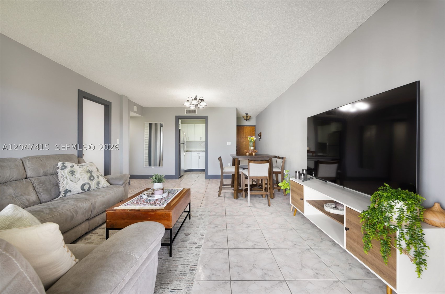 Move-in ready and beautifully updated, this bright and spacious 2-bedroom, 2-bath residence in Peninsula at International Gardens offers comfortable living with peaceful lake views. The thoughtfully remodeled kitchen features modern finishes, while the pristine bathrooms and in-unit washer and dryer add everyday convenience. The spacious primary suite includes a large walk-in closet, an ensuite bath, and direct access to an oversized private balcony with artificial turf—an inviting space to relax while overlooking the tranquil water. Abundant closet space throughout provides exceptional storage. Additional highlights include hurricane shutters, two assigned parking spaces, and a private storage unit. Residents enjoy a secure building with elevator access and a community pool. Ideally located just minutes from FIU, shopping, dining, and major highways, this updated condo offers an exceptional opportunity for both homeowners and investors seeking comfort, convenience, and a prime location.