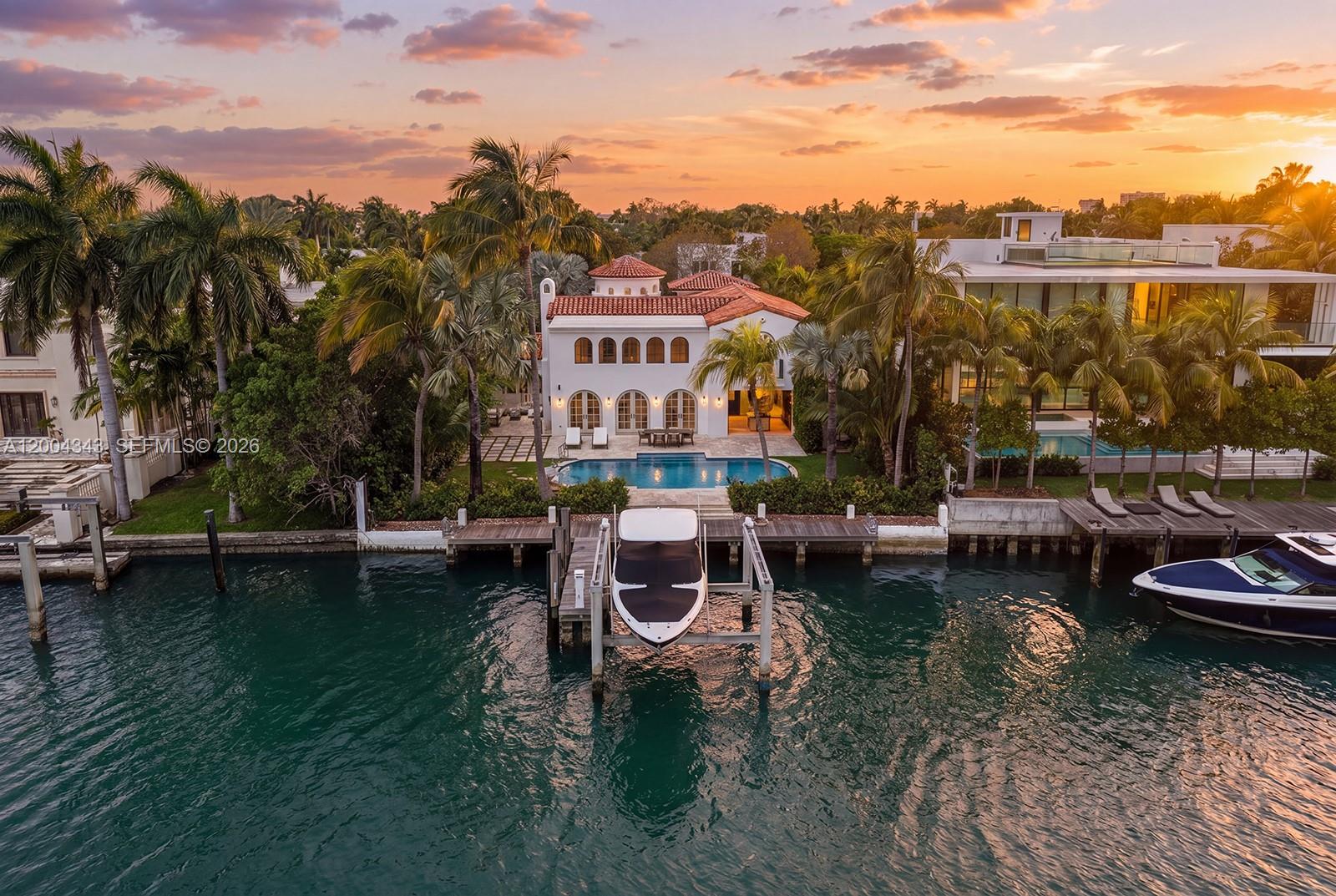 Behind a gated entrance on coveted Pine Tree Drive, this beautifully renovated waterfront retreat unfolds as a private sanctuary on a 12,920 SF lot with 76 feet of water frontage. Lush landscaping and understated elegance set the tone, while wide water views create a serene backdrop throughout. Light-filled, open living spaces with wide plank oak flooring flow seamlessly indoors to out, with expansive terraces & outdoor living areas.  This home is made for effortless entertaining with a luxurious bar featuring natural stone and custom millwork. Unwind out by your sparkling pool & take in cool bay breezes. This 5-bedroom, 5.5-bath home offers comfort and refinement, featuring 4 bedrooms in the main residence and a separate guest house with an additional bedroom for visitors. Upstairs, the oversized principal suite is a tranquil oasis with a striking marble bath and double height ceilings. Enjoy living in this tropical haven in the heart of Miami Beach.