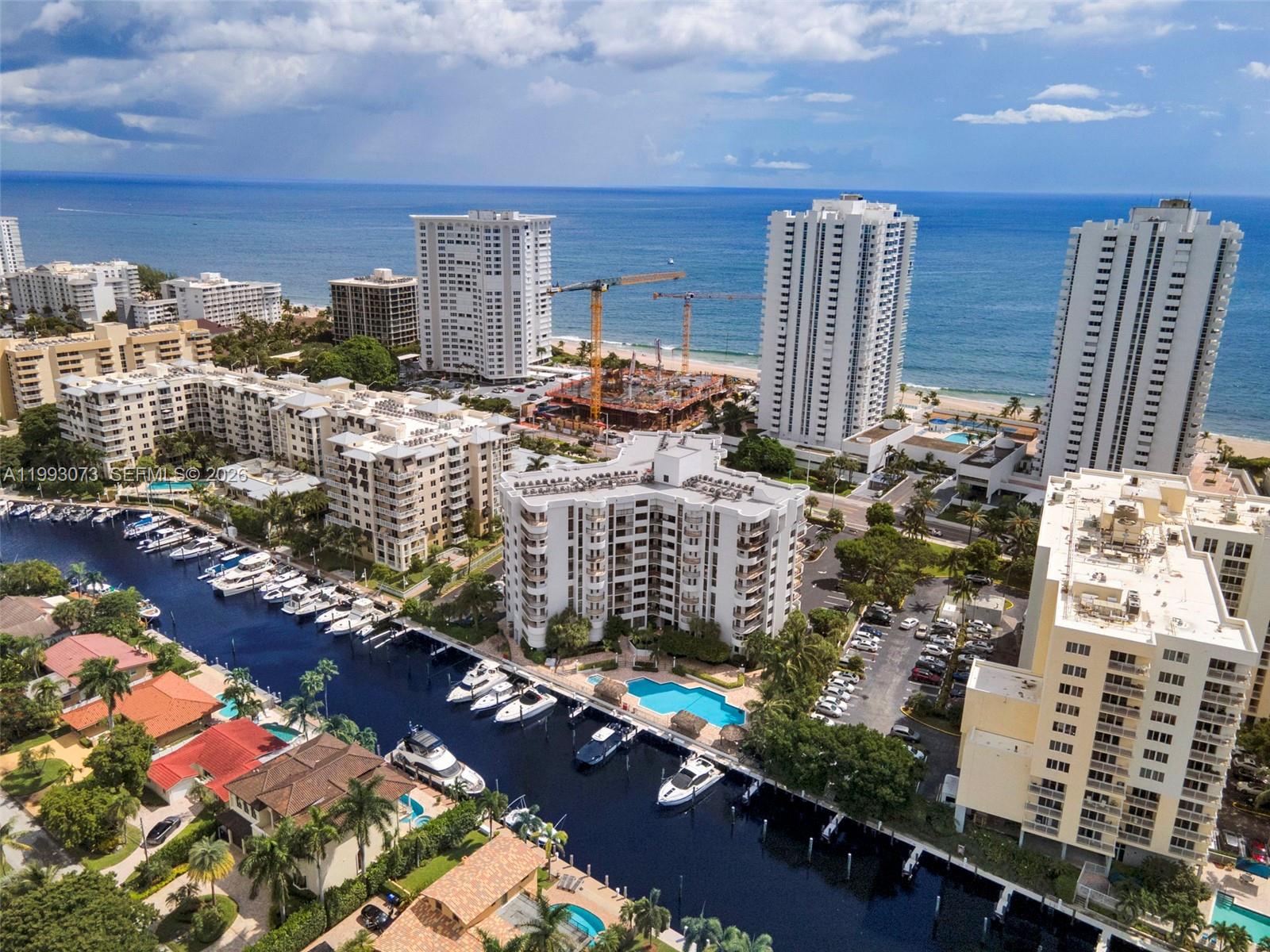 Exceptional oceanfront treasure - a rare pet-friendly building featuring a well-designed two-bedroom split layout with dual balconies offering ocean views. Elegant porcelain flooring throughout, and a gourmet kitchen appointed with rich hardwood cabinetry, granite countertops, and premium KitchenAid appliances. The primary suite opens to a private balcony and includes an en-suite with walk-in shower, bidet, and custom-designed closet. The second bedroom also features its own balcony and beautifully updated bathroom. Washer and Dryer in unit. Hurricane-impact windows throughout! Amenities: pool, outdoor kitchen for al fresco entertaining, bike storage, and boat slips. Assessments paid! New roof! 40 year complete and certified. Sellers have already moved out. MOTIVATED!