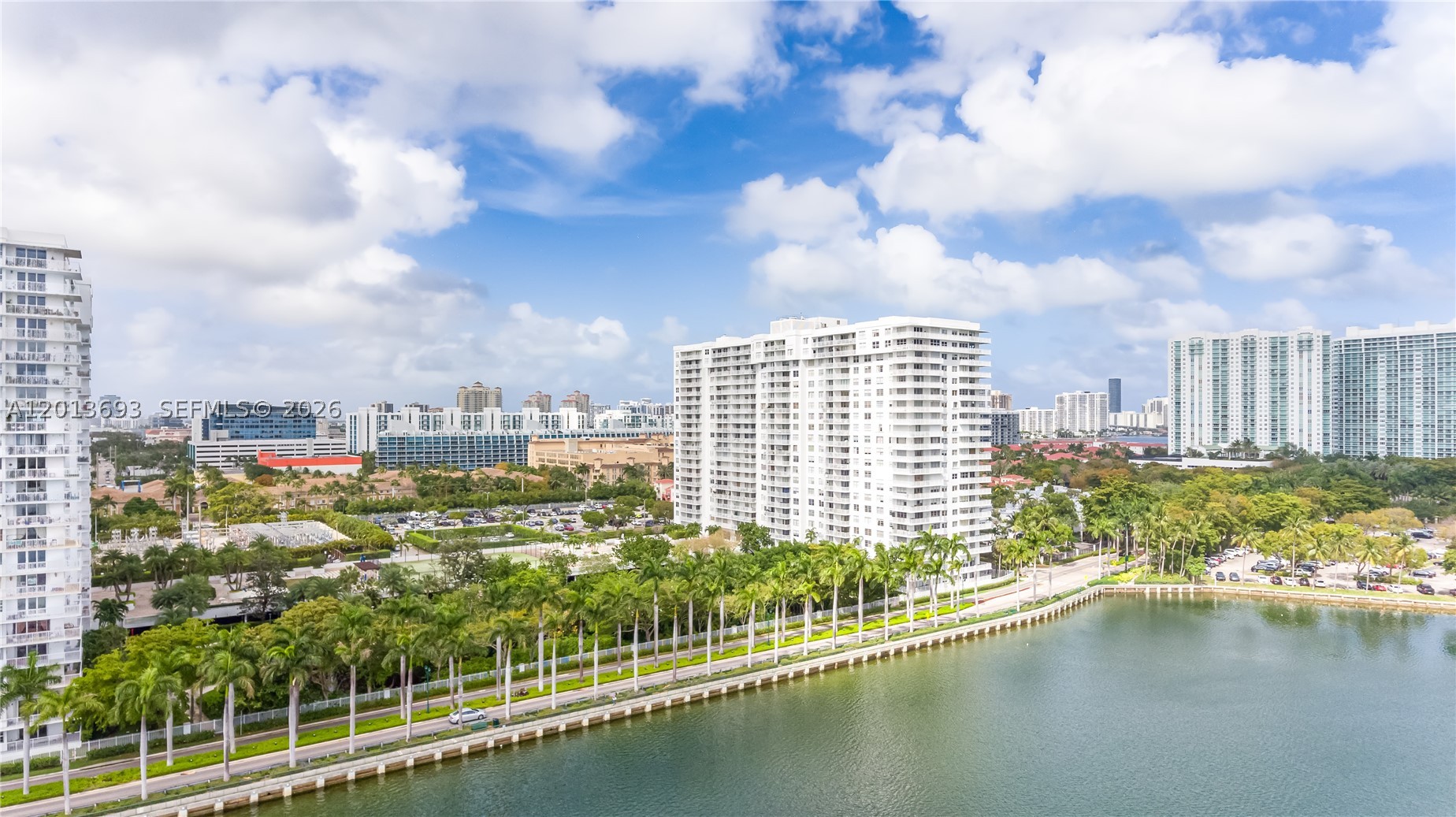 JUST REDUCED, IMMEDIATE OCCUPANCY / VACANT NOW! Skip the wait and move right into this spectacular, fully renovated high-floor residence at Admirals Port. Spanning over 1,460 sq. ft., this bright, spacious, and completely vacant 2-bedroom, 2-bathroom home is an immaculate blank canvas ready for your personal touch. Features include modern light-reflecting flooring throughout, contemporary recessed LED lighting, and a custom built-in dry bar with an integrated wine cooler. The gorgeous open-concept kitchen is equipped with high-gloss white cabinetry, smart LG ThinQ appliances, and premium quartz countertops with a dramatic waterfall edge. The primary suite offers a customized walk-in closet and a spa-like bath with a custom blue-onyx porcelain rain shower and backlit LED mirrors. Step onto the private balcony to enjoy a dynamic, high-floor view overlooking the active tennis courts and resort pool directly below, with a beautiful lateral view of Maule Lake opening up to the left. Important Note for Buyers: The tenant is departing at the end of May 2026, making this unit perfect for owner-occupants wanting immediate occupancy. The building requires 2 year of ownership before renting, ensuring a quiet, stable, and highly desirable residential community. Minutes to Aventura Mall, fine dining, and houses of worship. Easy to show and ready for a fast closing!