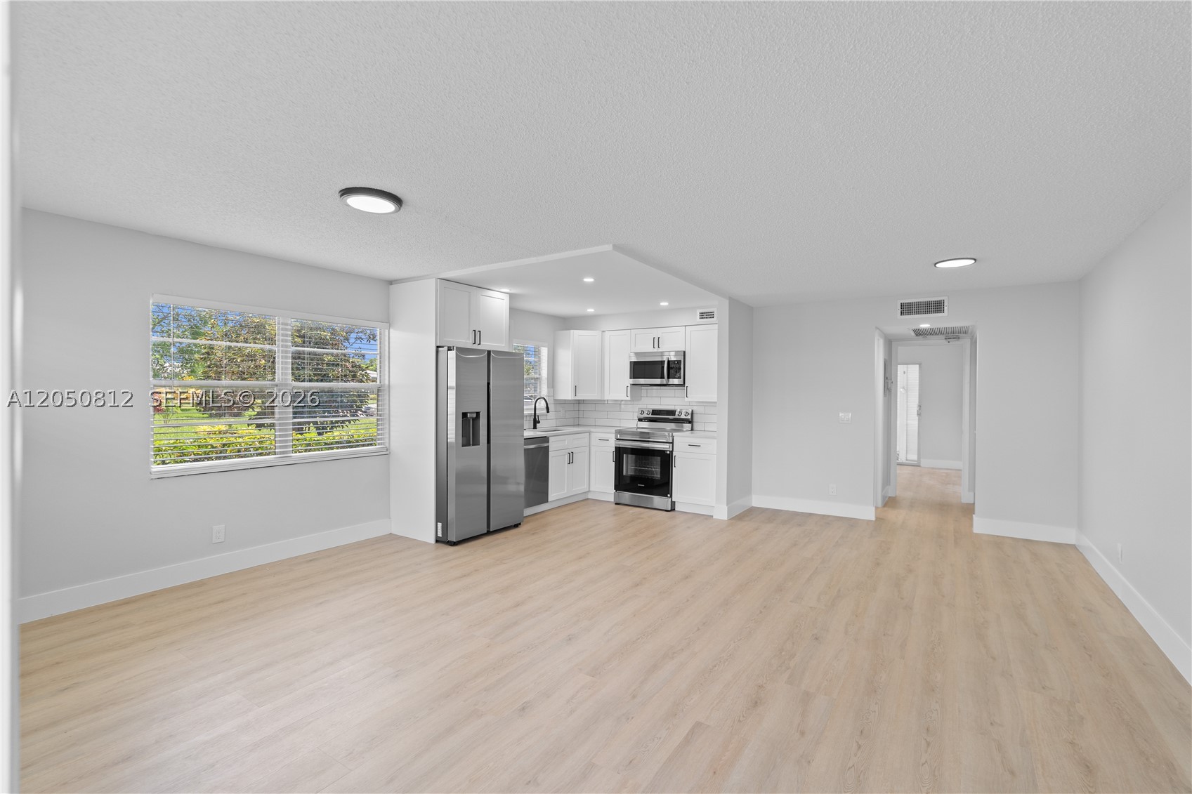 Welcome to this beautifully updated 1-bedroom, 1.5-bath first-floor condo in the highly sought-after Oakridge section of Century Village Deerfield Beach. This move-in ready home features a bright, open-concept layout with a renovated kitchen showcasing updated cabinetry, countertops, backsplash, and new stainless steel appliances. Both bathrooms have been tastefully remodeled. Recent upgrades include a new tankless water heater, central A/C, new electrical panel, updated lighting, modern fixtures, and a spacious enclosed patio. Enjoy the exceptional Century Village lifestyle with resort-style amenities including a clubhouse, pools, fitness center, tennis and pickleball courts, theater, restaurant, social activities, and courtesy bus transportation. Conveniently located just minutes from shopping, dining, and major highways.