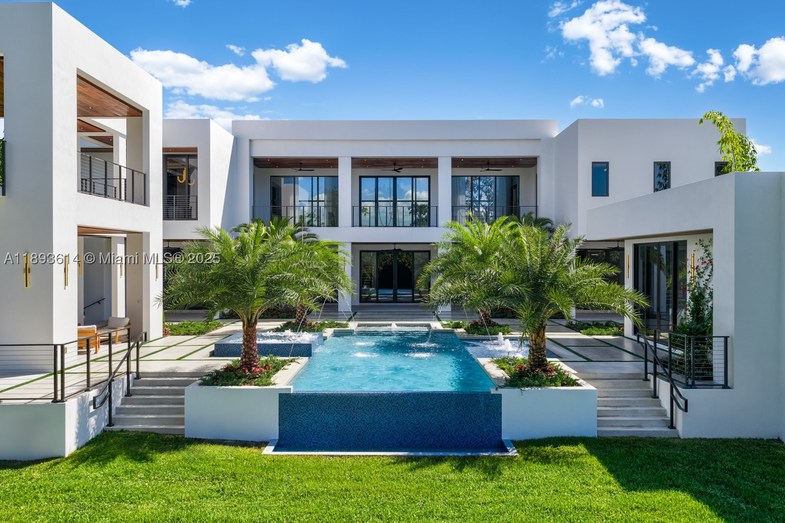 A statement of modern architecture & artistry, this 2025 estate reimagines luxury living on over an acre of resort-caliber grounds. Spanning 12,000+ sq ft, including a 1,000 sq ft guest home, every inch reflects uncompromising design & craftsmanship. Soaring 28 ft ceilings, custom murals, a floating glass staircase, private elevator, & showpiece fireplace define its elegance & scale. The chef’s kitchen, Lutron automation, & full smart-home integration blend innovation with comfort. 14 ft high garage bays fit multiple lifts. The primary wing unveils a private terrace & custom closets. Outdoors rival a five-star resort with a full summer kitchen, covered pavilions, poolside lounge, & expansive grounds ideal for courts or gardens. A true jewel—extraordinary, extravagant, & undeniably refined.