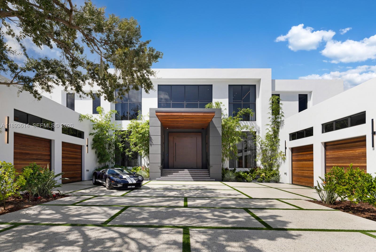 A statement of modern architecture & artistry, this 2025 estate reimagines luxury living on over an acre of resort-caliber grounds. Spanning 12,000+ sq ft, including a 1,000 sq ft guest home, every inch reflects uncompromising design & craftsmanship. Soaring 28 ft ceilings, custom murals, a floating glass staircase, private elevator, & showpiece fireplace define its elegance & scale. The chef’s kitchen, Lutron automation, & full smart-home integration blend innovation with comfort. 14 ft high garage bays fit multiple lifts. The primary wing unveils a private terrace & custom closets. Outdoors rival a five-star resort with a full summer kitchen, covered pavilions, poolside lounge, & expansive grounds ideal for courts or gardens. A true jewel—extraordinary, extravagant, & undeniably refined.