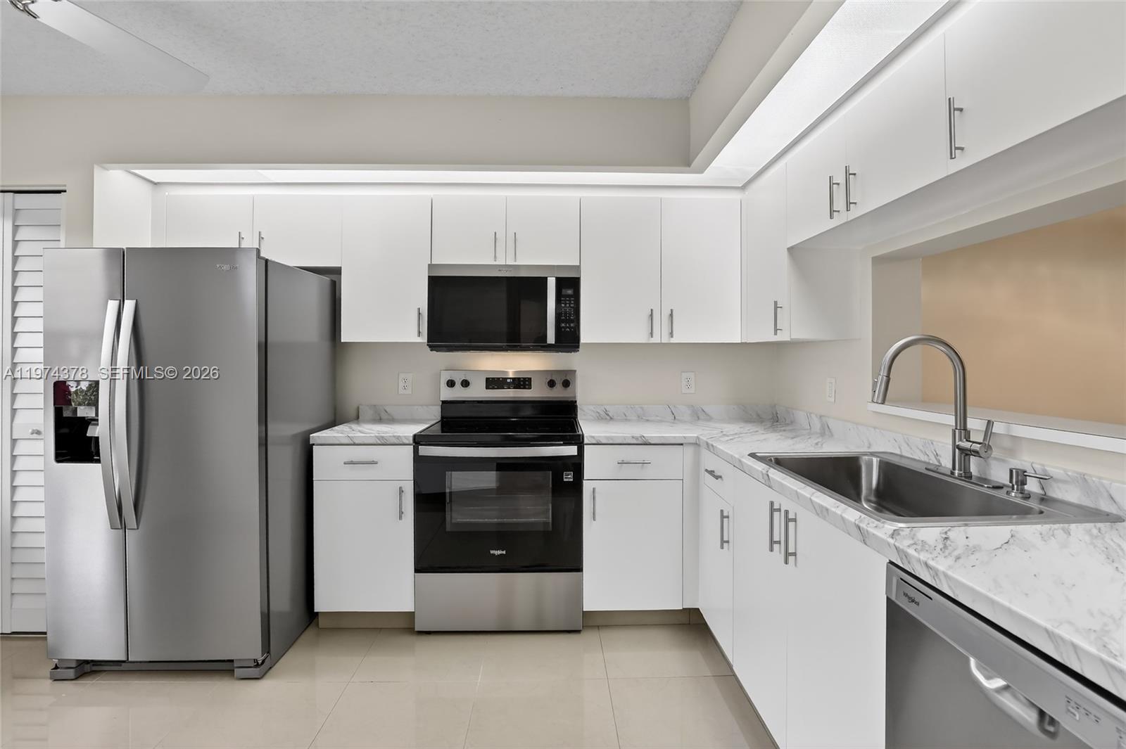 Enjoy peaceful mornings in this beautifully upgraded first-floor condo located in the highly desirable Century Village Pembroke Pines, one of South Florida’s most amenity-rich 55+ communities. This home offers not only comfort and style but also an exceptional lifestyle.

The upgraded kitchen features brand-new stainless-steel appliances, new countertop, sink, faucet, and pantry door. Bathrooms have been fully refreshed with new vanities, lighted mirrors, modern lighting, toilets, exhaust fans, and updated shower fixtures. Additional upgrades include new flooring and baseboards throughout, freshly painted interior, and a convenient in-unit washer and dryer. A/C replaced in 2024. Assigned parking is located just steps from the unit.

Residents enjoy resort-style living with access to an impressive array of amenities, including a 1,042-seat theater with live performances, fitness centers, indoor and outdoor pools, sauna, pickleball and tennis courts, billiards and card rooms, library, and numerous clubs and social activities. The community also features a par-71 golf course, on-site restaurant, and medical center, along with 24/7 gated security.

An active social calendar offers something to enjoy every day. At least one resident must be 55+.