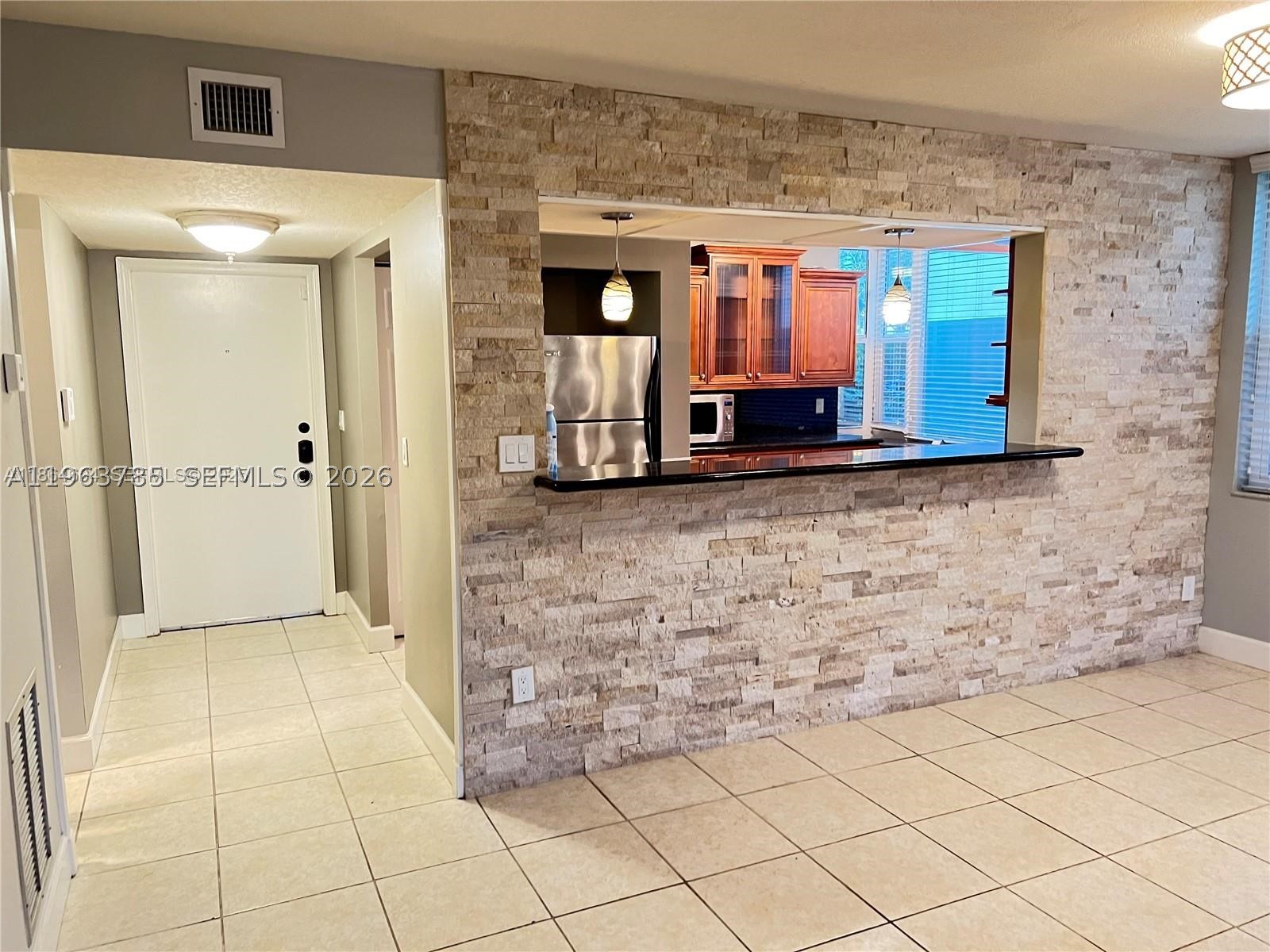 Beautifully updated ground-floor corner unit in a boutique 22-unit building, featuring a bright and spacious layout with large impact windows, a generous bedroom with walk-in closet, modern kitchen with granite countertops, stainless steel appliances, upgraded cabinetry, in-unit washer and dryer, and assigned storage. NO SPECIAL ASSESSMENTS! Located in one of the area's most desirable and walkable neighborhoods, just steps from Publix, Starbucks, restaurants, and shops. Strong rental potential with comparable units renting for around $2,200/month. Exceptional value, a wonderful neighborhood, and a highly motivated seller—bring your offers! MOTIVATED SELLER