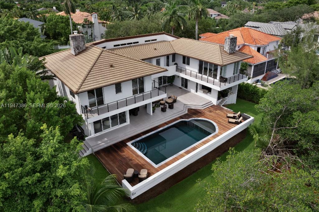 Set against the uninterrupted greenery of Fairchild Tropical Gardens, one of two botanical gardens in the continental U.S., this exceptional Coral Gables residence within gated Hammock Oaks Harbour offers a rare combination of privacy, nature, and direct ocean access via a deeded boat slip — a lifestyle difficult to replicate. 

Other features of this private oasis include a large home gym, dedicated kids playroom/music room, a home office, and a 1200+ bottle wine cellar.