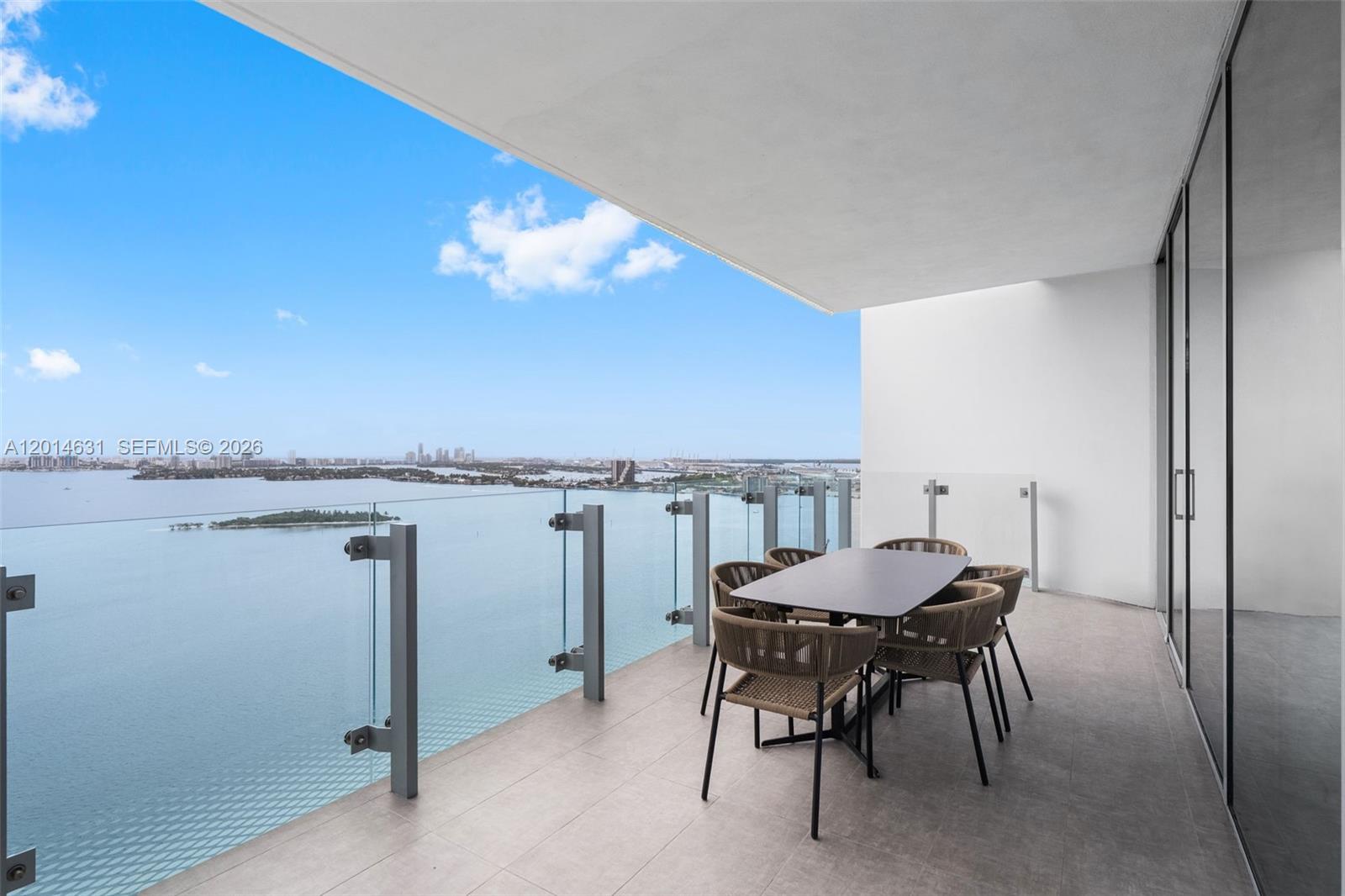 Welcome to elevated waterfront living at Missoni Baia, Edgewater’s premier luxury bayfront address. Residence 2803 showcases breathtaking panoramic views of Biscayne Bay and the Miami skyline through floor-to-ceiling impact glass and expansive terraces designed to maximize indoor-outdoor living. This beautifully appointed 2-bedroom, 2-bath residence features a sophisticated open-concept layout with porcelain tile flooring throughout, a sleek chef’s kitchen with custom cabinetry, premium integrated appliances, and an oversized waterfall island ideal for entertaining. The spacious living and dining areas are filled with natural light and framed by stunning water and city views from nearly every room.  The serene primary suite offers direct bay views, generous storage, and a spa-inspired bathroom with refined contemporary finishes. Missoni Baia offers an unmatched resort-style lifestyle with world-class amenities including three waterfront pools, a state-of-the-art fitness center with Pilates studio, luxurious spa with sauna and steam rooms, tennis courts, pet spa, kids’ club, game lounge, resident lounges, and 24-hour concierge services. HOA includes internet, cable, water, resort-style amenities, and assigned garage parking.