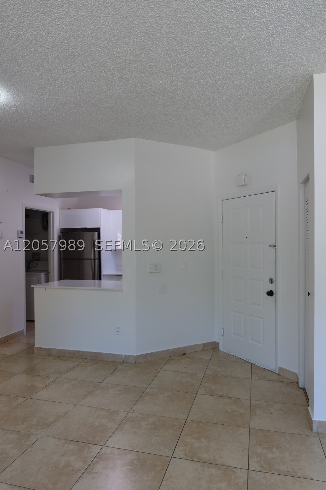 Investors! See this beautifully updated condo! This bright, open floor plan features a new kitchen with stainless steel appliances and vaulted ceilings, creating an airy, spacious feel. Enjoy the convenience of an in-unit washer and dryer, laundry room, and extra storage closet. It is the perfect area for a home office, gym, or yoga space. Freshly painted and ready for its new owner. Parking right in front of the unit. Community amenities include a pool, clubhouse, spa, basketball and tennis courts, and playground. No rental restrictions. Easy access to I-75 and the Palmetto Expressway. Roof and exterior maintenance are included in the association fee.