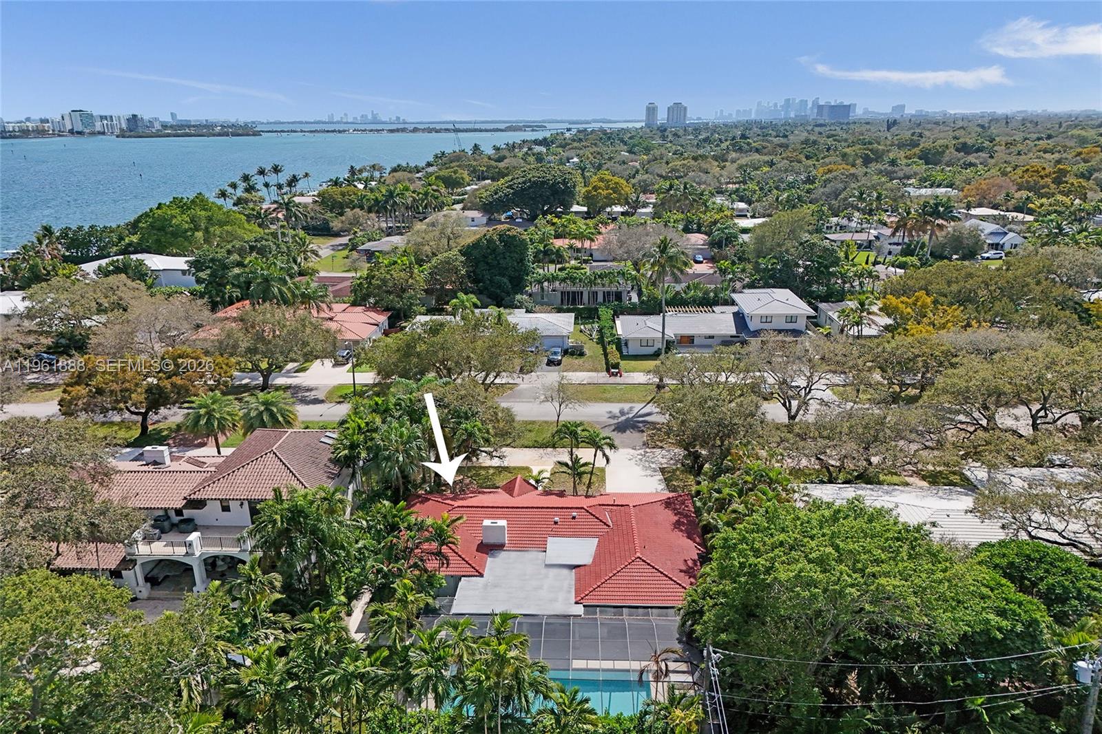 Beautiful opportunity to own a home in East Miami Shores! This spacious classy home is on a lager then normal lot 11,180 sqft with a very large screened in Pool! Tons of natural light and lots of entertaining space this big 3 bedroom, 3 bathroom w/garage is perfect and well maintained. Gourmet gas kitchen with granite countertops, custom wood cabinetry & high-end stainless steel appliances. Elegant fireplace and full gas generator. Interior upgrades include five-inch baseboards, travertine and hardwood flooring, solid wood doors, cedar-lined closets, LED recessed lighting, designer fixtures. Luxurious primary bathroom is larger than normal with huge walk in closets. Almost new Roof, less than two years old. Outdoors, enjoy beautiful coral stone tile surrounding the pool—perfect for South Florida living. Lets not forget this is a historical street; one of the best streets in Miami Shores with Doublesized side-walks and surrounded by huge new construction homes on similar sized lots!