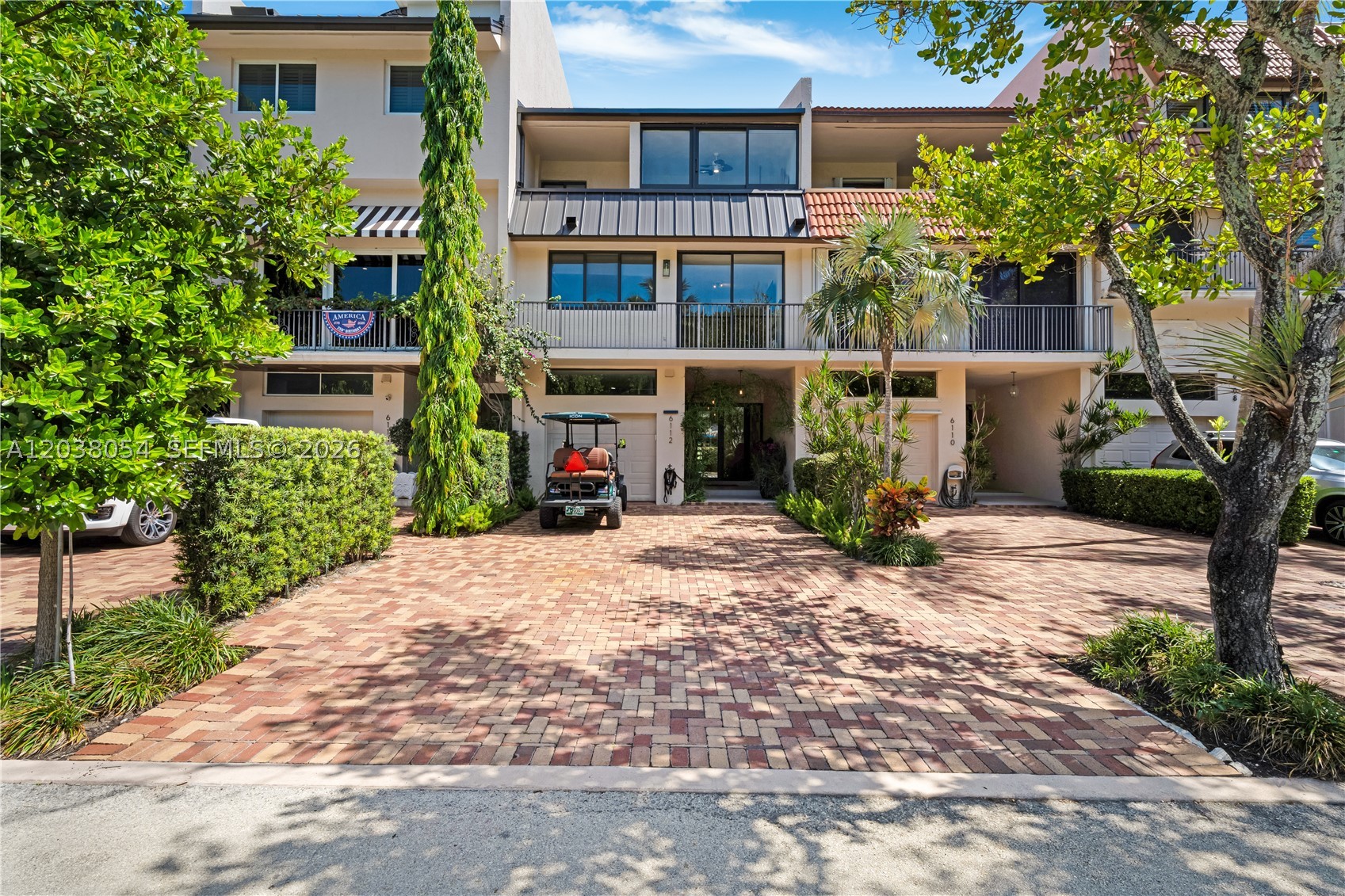 Welcome to The Sandbar House, a beautifully appointed tri-level waterfront retreat in the exclusive Royal Harbour Yacht Club. Offered fully furnished, this exceptional residence captures breathtaking bay-to-ocean views and overlooks the resort-style community pool from multiple private terraces. Thoughtfully designed for luxury living, the home features a gourmet chef's kitchen with premium appliances, an oversized island, custom cabinetry, handcrafted wood doors, and stunning built-ins throughout. Recent upgrades include a new metal roof, impact windows and doors, and a newer HVAC system, providing peace of mind and modern efficiency. An in-home elevator offers effortless access to all three levels. Community Amenities include: 24 Hour Guard with secured entrance, Full Service Marina, Gym, Heated Pool and Spa, Clubhouse, Tennis and Pickleball Courts, Beach, Nature Trail and Boardwalk by the water. For boating enthusiasts, a private dock may be available separately for purchase, providing direct access to Biscayne Bay. Live where every day feels like a vacation at The Sandbar House.