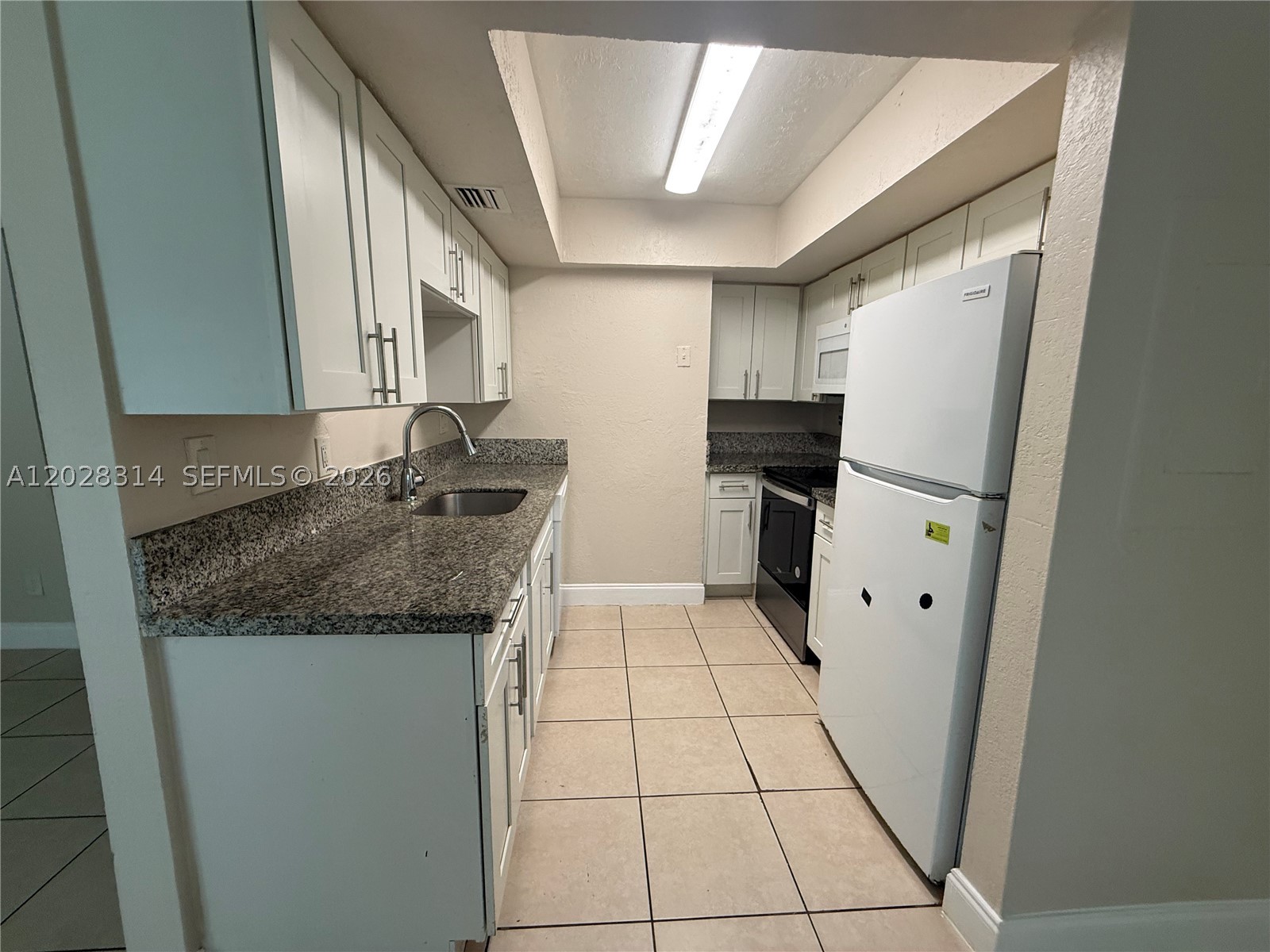 Nice and well-maintained 2-bedroom, 1.5-bathroom townhouse centrally located in Lauderhill. This home features an updated kitchen with modern white cabinets, granite countertops, and a clean, bright design with neutral colors throughout.
The second floor offers beautiful wood-style flooring, a new wood staircase, and fresh interior paint, giving the home a refreshed and comfortable feel. Enjoy a spacious private fenced backyard, perfect for relaxing, entertaining, or creating your own outdoor space.
The detached garage is conveniently located within walking distance and provides additional storage space. This townhouse is move in ready, great condition, located in a central location close to shopping, dining, and major roadways.