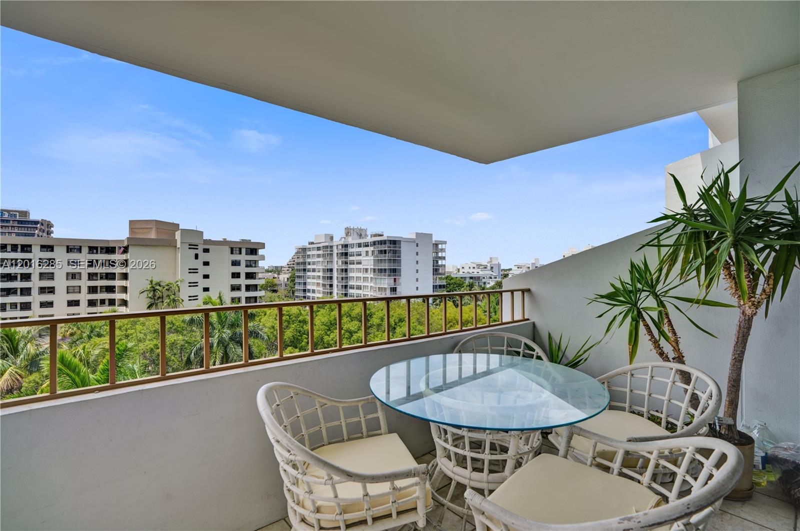 SOUTH VIEWS FROM THIS ONE BEDROOM, ONE AND 1/2 BATHS COMMODORE WEST HOME. THE ATLANTIC OCEAN AND BISCAYNE BAY CAN BE VIEWED FROM THE LONG BALCONY.  The primary bedroom has 2 closets, one a walk-in. Marble bathroom. Separate storage and laundry room steps away. One assigned, UPPER LEVEL garage parking space. Commodore Club is a very well-maintained building with many amenities such as direct and private beach access where umbrellas and chairs are provided, tennis courts, a heated pool, exercise room, electric car chargers and community room.