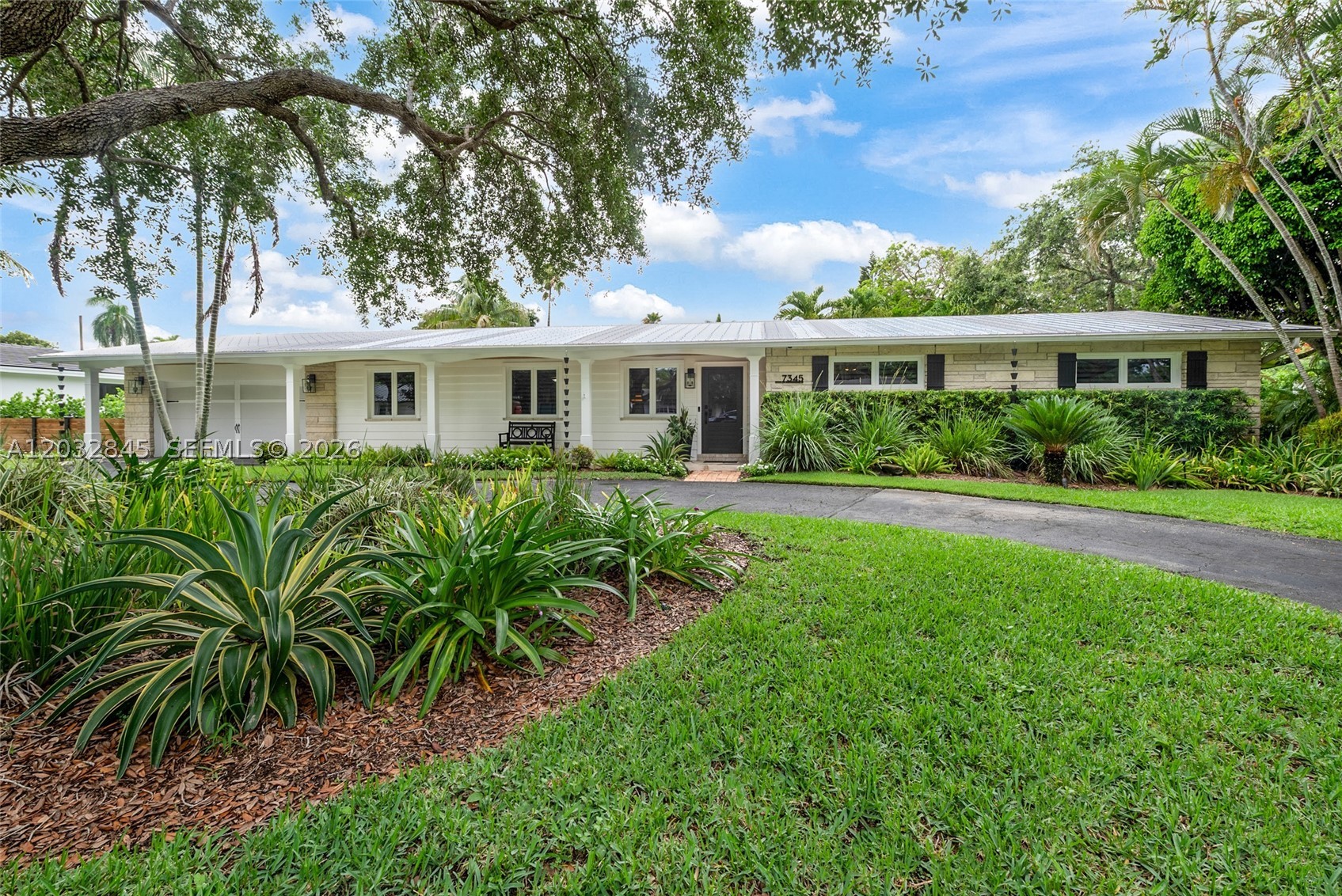 Completely remodeled and move-in ready, this exceptional Pinecrest estate offers the perfect blend of style and comfort. Features include an updated eat-in kitchen with stainless steel appliances, granite countertops, subway tile backsplash and porcelain tile floors. The spacious layout includes 4 bedrooms plus a home office, and 3 full baths, impact windows and doors, plantation shutters, and solid maple wood flooring throughout the main living areas. The primary suite features dual closets, double vanities, and a frameless glass shower. Formal living, dining, and family rooms complement the beautifully updated bathrooms and plumbing. Additional highlights include an indoor laundry room, circular driveway, 2-car garage and a metal roof. Enjoy tranquil views of the renovated pool and patio area. A truly turnkey Pinecrest residence.