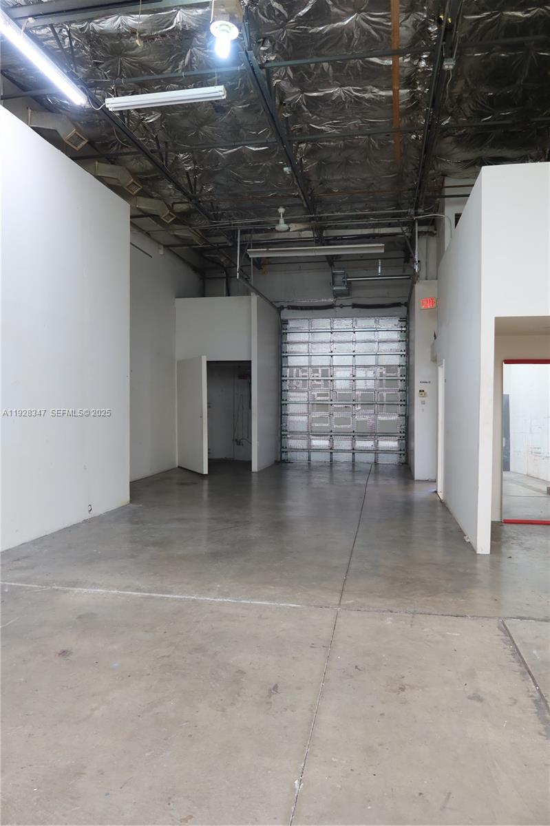 Introducing a prime opportunity to secure a highly versatile 2,005 SF industrial condo in one of Miami’s most strategically located commercial corridors. This well-appointed warehouse unit offers an exceptional blend of functional workspace and office potential, ideal for a wide range of business operations—from distribution and storage to creative or service-based uses.

The property features a street-level, front-facing loading door with excellent visibility and a 20’ clear ceiling height, providing efficient flow for equipment, vehicles, and inventory. Two interior car lifts, included in the sale, offer added utility for automotive or mechanical businesses. A dedicated entry leads directly into the office area, ensuring smooth separation between administrative and warehouse functions.

Positioned just minutes from Aventura, Bal Harbour, Biscayne Park, and Miami Shores, the location offers unparalleled convenience with quick access to I-95 and Biscayne Blvd—perfect for companies prioritizing connectivity and logistics.

Whether you’re an end-user aiming to establish or expand your business presence, or an investor seeking a high-demand industrial asset, this property represents a rare chance to acquire a well-located warehouse in a market where opportunities of this caliber seldom become available.

Monthly Maintenance $972
