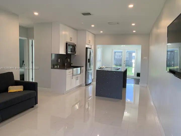 Beautifully remodeled, unfurnished & spacious 2 bedroom home in the quiet neighborhood of West Park. This home features impact windows, new tile floors throughout, beautiful large size kitchen and a big backyard. Covered parking. Home is also available furnished for $3,000/month.