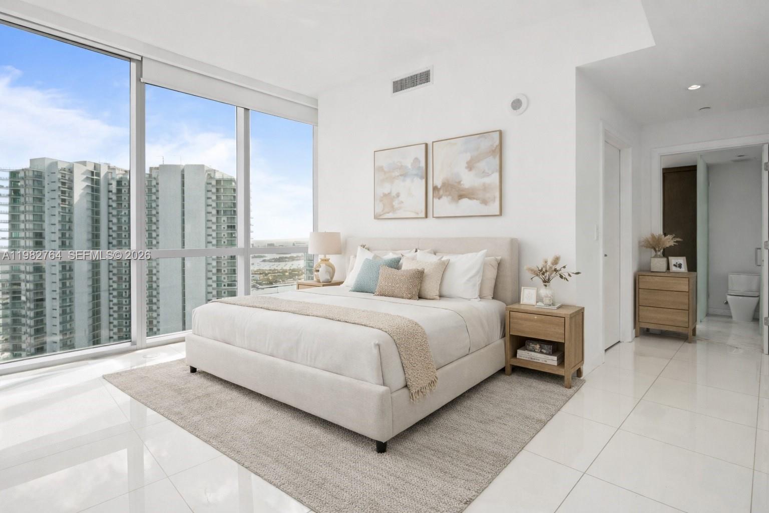 Spacious high-floor residence at Paramount Miami Worldcenter offering approximately 2,204 sq ft of interior living space with 10-foot ceilings, floor-to-ceiling windows, and expansive terraces with city views. Located on the 48th floor, just below the penthouse level, the unit offers exceptional light and panoramic views. Modern European-style kitchen with quartz island, sleek cabinetry, stone backsplash, and premium Bosch appliances. 
This unique unit is configured as two separate sections with independent entrances: a studio and a 2-bedroom plus den residence, offering flexibility for extended family, guests, or a home office setup. Paramount Miami Worldcenter is one of Downtown Miami’s most sought-after luxury buildings featuring over 40 world-class amenities including resort-style pools, private cabanas, tennis courts, boxing studio, golf simulator, full-size soccer field, and spectacular Skydeck with panoramic views. Enjoy world-class amenities: 5 pools, 24/7 fitness center, spa, private tennis courts, theater room, kids’ play area Prime Downtown location within walking distance to Perez Art Museum, Frost Museum of Science, Kaseya Center, and Miami Worldcenter shopping and dining.