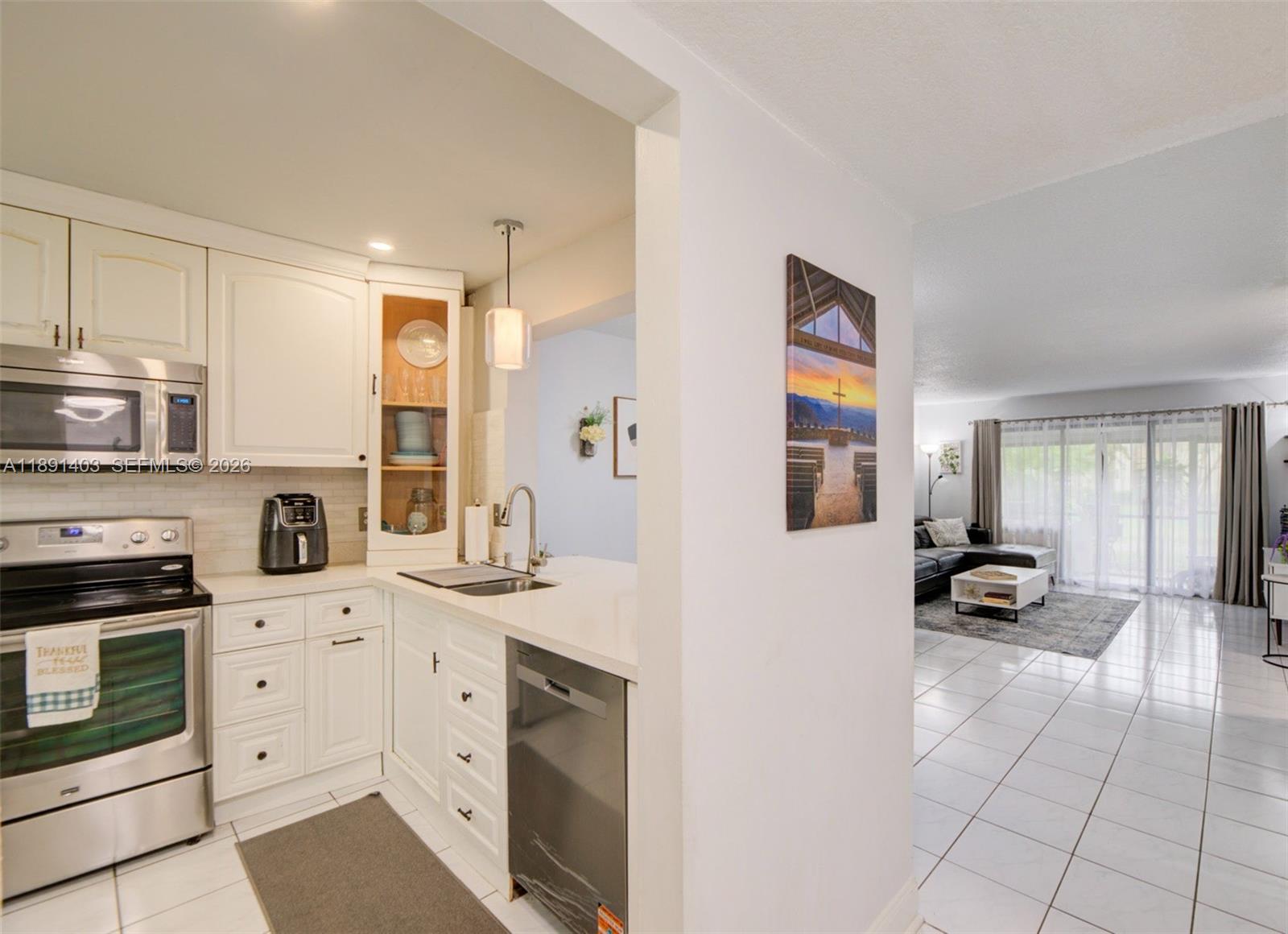 Best-Priced Opportunity in the Area! Beautifully remodeled ground floor condo in desirable Coconut Creek offering 2 bed 2 bath with peaceful canal and green space views. Bright spacious residence features an open layout, tile flooring throughout the main living areas, generous living, dining spaces, sliding glass doors leading to a private screened patio ideal for relaxing or entertaining. Updated kitchen showcases white cabinetry, quartz countertops, stainless steel appliances, breakfast bar, ample storage,  dishwasher 2024, opening seamlessly to the living area. The expansive primary suite offers wood style flooring, recessed lighting, oversized mirrored closets, and a remodeled private bathroom with modern walk in shower. Guest bathroom has also been tastefully updated. Additional features include full size washer and dryer 2024, water heater 2024, HVAC estimated 2013-2016, modern fixtures, generous storage, and the added privacy of a well maintained corner unit. Association fee includes roof maintenance, water, cable TV, and pest control. Enjoy Township resort style amenities including clubhouse, pools, fitness center, tennis courts, basketball courts, scenic walking paths, parks, lakeside areas, and outdoor spaces. Prime location minutes from The Promenade at Coconut Creek, Publix, dining, shopping, everyday essentials, major highways, nearby schools. Excellent opportunity for buyers seeking comfort, convenience, upgrades, water views, and South Florida living.