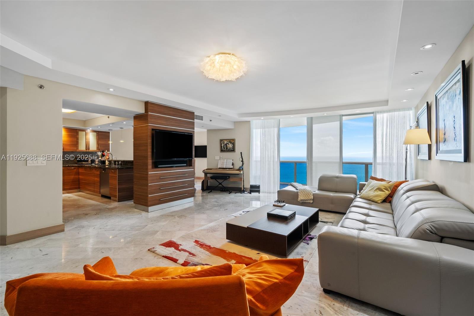 Experience luxurious oceanfront living in this beautifully upgraded 3-bedroom, 3.5-bath residence at the prestigious Ocean Four in Sunny Isles Beach. This expansive 3,018 SF home welcomes you with a grand open layout, polished marble floors, and floor-to-ceiling glass that frames breathtaking, unobstructed ocean views. The elegant living area features custom wood paneling, modern recessed lighting, and seamless flow into the dining room and gourmet kitchen. Designed for the culinary enthusiast, the kitchen boasts rich wood cabinetry, high-end stainless-steel appliances, sleek stone countertops, and a stylish breakfast bar perfect for entertaining. The oceanfront primary suite offers a serene retreat with panoramic water views, a private balcony, designer lighting, and generous closet space. Spa-inspired bathrooms showcase premium finishes and contemporary design. Additional features include a large laundry room, abundant storage, and refined craftsmanship throughout.
Located in one of Sunny Isles’ most coveted full-service buildings, residents enjoy private beach service, valet, pool, fitness center, spa, and concierge. Ideally positioned along the shoreline, this residence offers the perfect blend of luxury, comfort, and coastal sophistication.