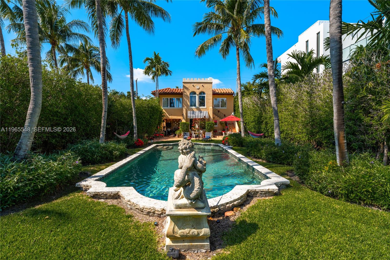 Chic, gated carriage house, Mediterranean style on a private expansive corner lot in the heart of Miami Beach. Fully enclosed by tall hedges and wrought iron gates, this one-of-a-kind property offers exceptional privacy, one block from the beautiful PineTree Dog Park, just a few blocks from the ocean and four blocks from shopping, dining and houses of worship. Minutes away from La Gorce Country Club and Miami Beach Golf Club.

The residence features warm architectural details, terracotta floors, wood shutters, a charming fireplace, and seamless indoor–outdoor living. Two renovated kitchens, positioned on separate levels provide rare flexibility for entertaining, extended family, or private guest accommodations.
Large living room upstairs with two bedrooms (one is used as a closet) full renovated bathroom and kitchen.

A fully equipped studio apartment on the lower level offers its own distinct living space, ideal for in-laws, long-term guests, home office, or potential rental income.

The lush front garden creates a true private peaceful retreat, showcasing a sparkling heated/cooled pool with fountain, majestic Royal palms, Chicago brick walkways, and a covered patio for year-round outdoor living. 
Security video cameras.
Ideal for end-users or investors seeking flexibility or potential income.

A rare offering for buyers seeking timeless architecture, privacy, and a true sense of place in the heart of Miami Beach.
