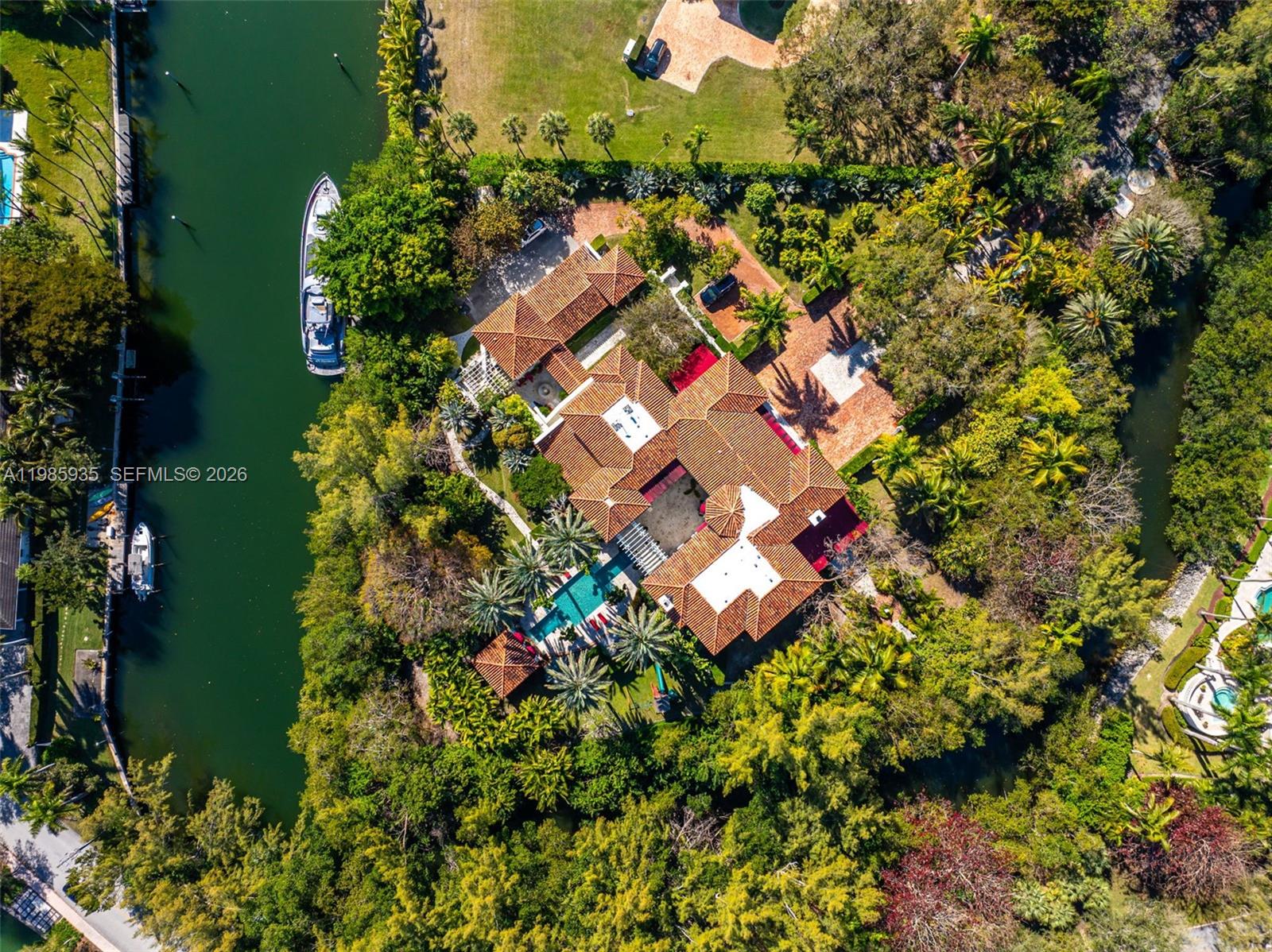 Nestled within the exclusive, gated, and 100% private enclave of Journey's End, this Tuscan-inspired waterfront estate epitomizes the pinnacle of Miami luxury living. Set on a private 2.1 acre peninsula with over 500 feet of pristine waterfront and private yacht dockage, the residence spans 13,825 SF of exquisitely designed interiors.  Featuring 7 opulent bedrooms, 8 full baths, and 2 half baths, the home offers unrivaled amenities including a state-of-the-art movie theater, wellness spa, multiple indoor and alfresco living spaces, a stunning pool w/cabana, and  guest house/staff quarters.  Enjoy access to two private tennis/pickellball courts for the exclusive use of the 18 homeowners in Journey's End.  Every detail has been meticulously curated to deliver sophistication,
privacy, and an unparalleled lifestyle for the most discerning buyer.