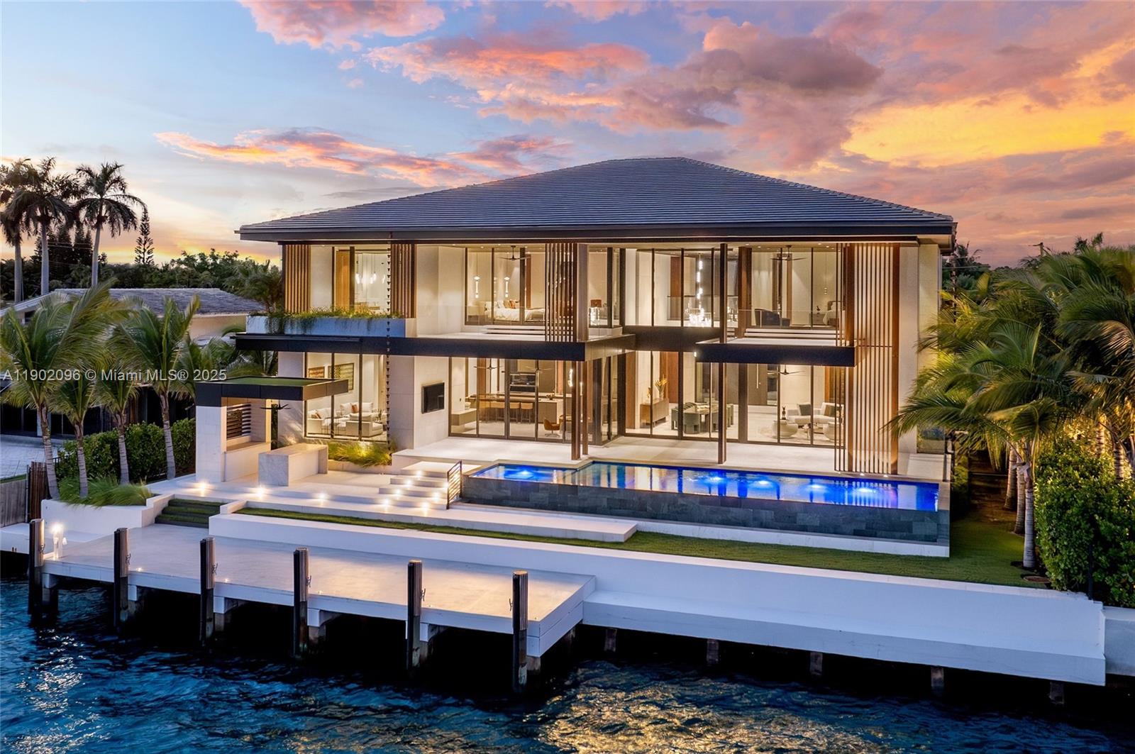 Experience uncompromising luxury in this newly completed tropical modern estate, set within the exclusive guard-gated enclave of Sans Souci Estates. Developed by Sunlight Homes and designed by Preschel Bassan Studio, this 8,000 SF residence offers 7 bedrooms including staff quarters, 7 full and 2 half baths. A stone façade opens to interiors with a chef’s and butler’s kitchen, custom millwork, imported stone, and European oak flooring. Features include a wine room, high ceilings, elevator, and 3-car garage. Outdoors, 103 feet of water frontage with new seawall and dock showcase bay views and downtown sunsets. Furnished by Minotti, Baxter, and other iconic brands, this is a rare modern masterpiece moments from world-class shopping, dining, and coastal attractions.