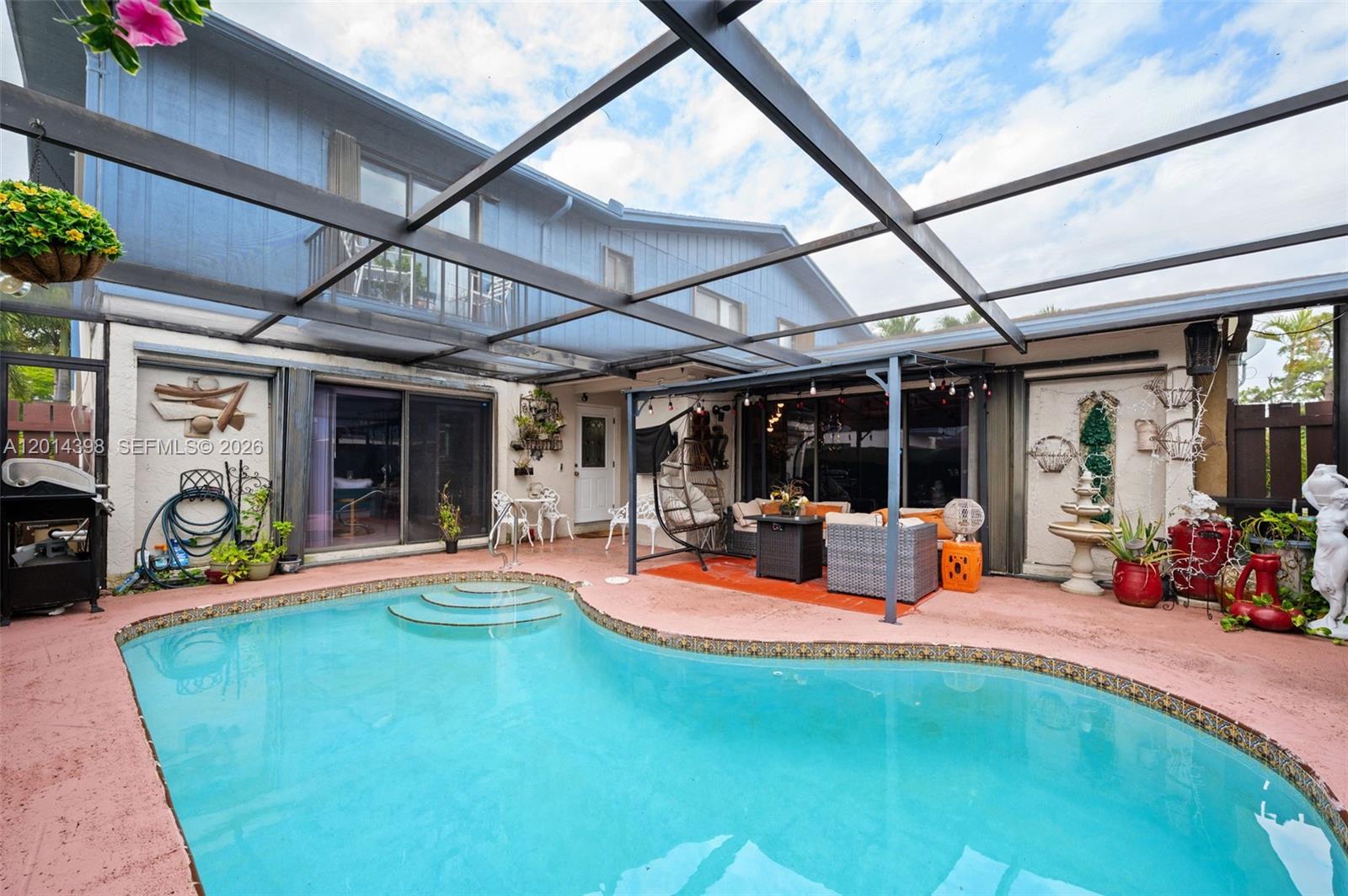 PRICE ADJUSTMENT for this unique town home located in the Country, Green Acres/Lake Worth, FL. This home has a lot to offer, downstairs living room can be a third bedroom, just add a closet and wall to make it a huge main bedroom. High ceilings and marble floors in the spacious family and dining room space. Lots of windows adding light to all rooms. Separate pantry/storage off the kitchen also houses the laundry room. Two large bedrooms with lots of closets and a full bath finish off the second floor. The piece-de-resistance is the private courtyard pool area, fully screened in to enjoy the outside all year long.  Imagine relaxing by the pool, soaking up the Florida sunshine, or entertaining guests in a space designed for both comfort and style. This home is perfect for those who value convenience and leisure, providing a serene retreat from the hustle and bustle of everyday life. Close to shopping, local restaurants and schools; easy access to I95 and FL Turnpike. You won't find a place like this one! Showings by appointment only! Make one today and don't miss this gem. Come, See, and Stay!