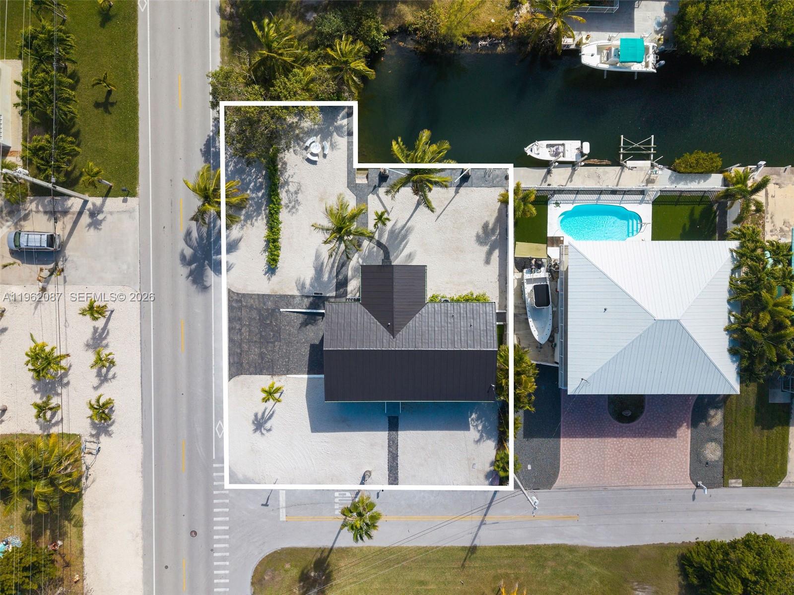 Welcome to island living in Big Pine Key. Situated on a desirable corner lot, this beautifully remodeled 3-bedroom, 2-bathroom home offers 70 feet of dockage with davits, providing excellent boating access and true waterfront Keys living. The home has been fully updated, featuring a newer roof, updated windows, modern flooring, renovated kitchen and bathrooms, and upgraded lighting throughout. The property also features a large garage and ample storage space, ideal for boating gear, tools, or recreational equipment. Enjoy privacy, outdoor living, and easy access to open water, nearby parks, and local amenities. A fantastic opportunity for a full-time residence, vacation retreat, or investment property in the Lower Keys.