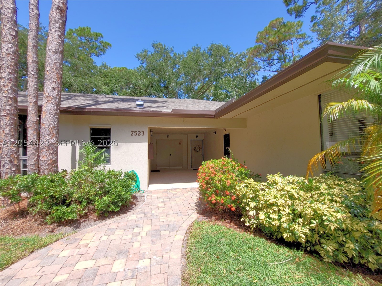 Florida tropical living at its finest! This rare, one-story villa is surrounded by lush greenery, creating a true tropical-oasis setting.
The home features a spacious living and dining room combination, a separate eat-in kitchen area, and tile flooring throughout the main living spaces. The kitchen offers new stainless steel appliances and quartzite countertops. The kitchen and bathroom cabinetry will be refreshed with new solid drawers, shaker-style doors, stainless steel pulls, and full-extension, soft-close hardware. The bedroom includes plantation shutters and a gigantic walk-in closet. The bathroom features a separate dressing area with sinks and a relaxing jetted tub. Additional conveniences include a washer and dryer inside the unit and ceiling fans along with screened front door and screened patio that allows you to enjoy the tropical breezes.
Step outside to the spacious screened-in patio, where you can start your day surrounded by nature, overlooking the lush tropical landscaping and watching wild peacocks roam the grounds. 
This beautifully landscaped, gated, all-ages community features two lakes with fountains, scenic walking paths, a clubhouse, and a community pool surrounded by lush landscaping and fruit trees. The villa includes Accordion and hurricane shutters provide added protection, plus one assigned covered carport space, along with plenty of guest parking!