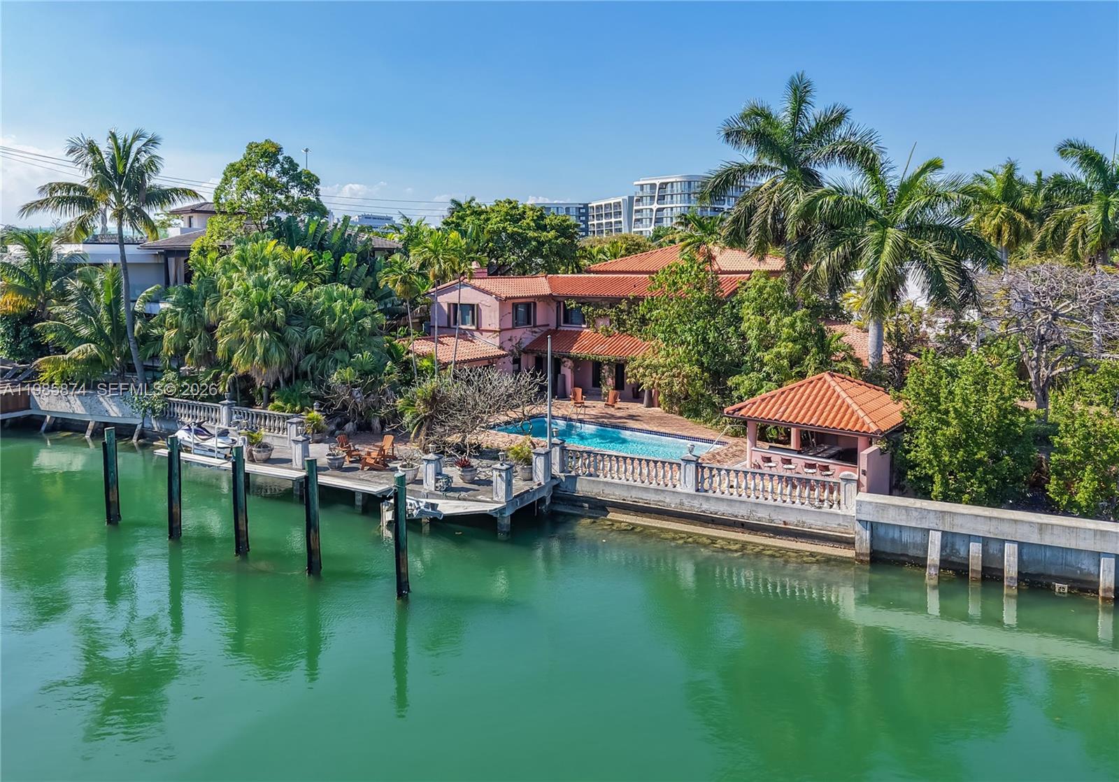 Exceptional waterfront opportunity in Mid-Beach, steps from St. Patrick’s, nestled on a quiet dead-end street. This 2-story residence offers over 5,000 sq ft with 6 bedrooms, 7 bathrooms, and a private office. Boasting 106 feet of canal frontage — well above average — on an 11,300sft lot and just one fixed bridge from the Bay. Sold as-is, this is your chance to unlock tremendous value at the lowest price per sq ft in the area — renovate or rebuild your dream waterfront estate. The lush grounds feature mature avocado, mango, and lychee trees, adding charm to this diamond in the rough. This much water frontage at this price point in Mid-Beach is exceptionally rare. Don’t miss your chance to own and transform one of Miami’s most coveted waterfront addresses.