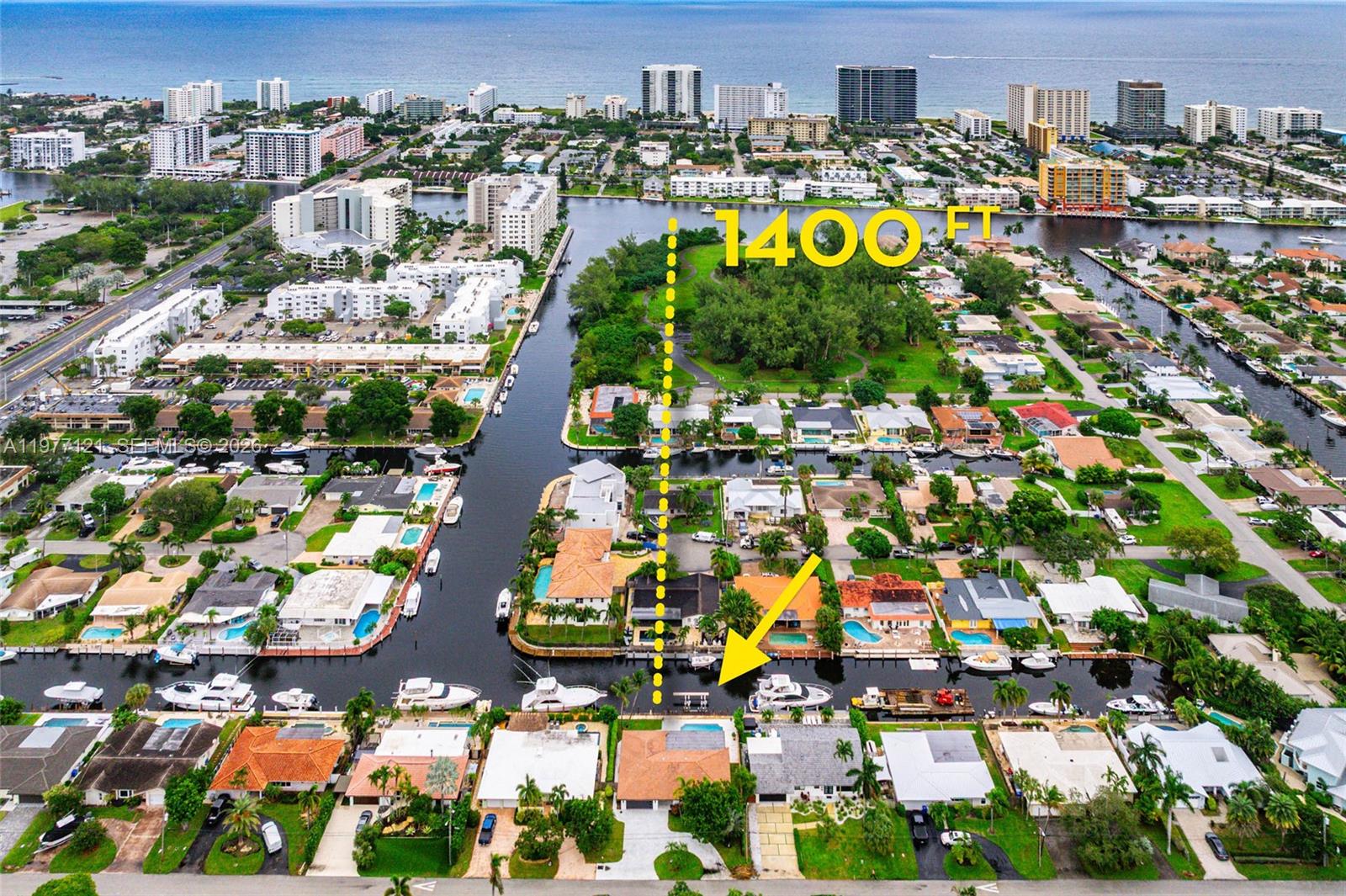 BOATER'S DREAM HOME AWAITS! NO FIXED BRIDGES! Exceptional waterfront living with a private full-service 80' dock dredged to 6' MLW, featuring a 35,000-lb BOAT LIFT (2024) and newer SEAWALL (2021). Ideally positioned by a turning basin with direct ocean access just minutes to open water. This beautifully renovated home offers a bright open floor plan, new ROOF (2024), and a stunning chef's kitchen with custom soft-close cabinetry, quartzite countertops, oversized island, flush-mount exhaust, and wine cooler. European-inspired finishes add modern elegance throughout. The expansive lanai with Egyptian marble pool decking creates the perfect setting for entertaining and relaxing while enjoying views of your yacht in the backyard. Epoxy-floored garage w/cabinetry, wet sink, and large attic!