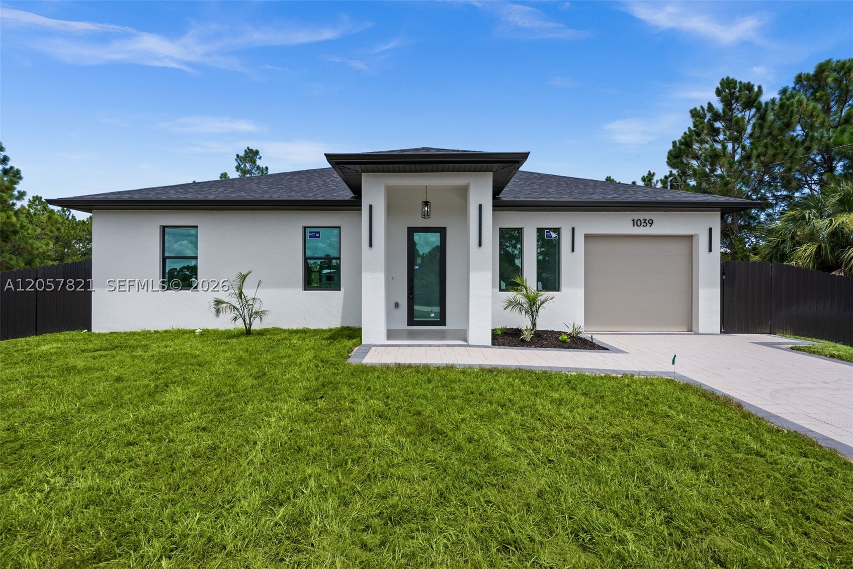 Welcome to this beautifully crafted 2026 NEW CONSTRUCTION offering 3 bedrooms, 2 bathrooms, and 1,269 square feet of thoughtfully designed living space where MODERN DESIGN, QUALITY CRAFTSMANSHIP, and PREMIUM FINISHES come together. This CUSTOM HOME features an OPEN FLOOR PLAN with impressive 10-foot ceilings, elegant 8-foot interior doors, modern 6-inch baseboards, and tile flooring throughout, creating a bright and spacious atmosphere. The European-inspired kitchen showcases QUARTZ countertops, a FULL QUARTZ BACKSPLASH, modern cabinetry, a large island with decorative accent panels, a custom coffee station, and a complete stainless steel appliance package. The living room and primary bedroom feature designer accent walls that enhance the home's contemporary style.

Built with both beauty and durability in mind, this home includes IMPACT-RESISTANT WINDOWS AND DOORS with LOW-E GLASS, a paver driveway, an epoxy-coated garage floor, an automatic irrigation system, LED exterior lighting, and a fully fenced backyard. The spacious open lanai provides the perfect setting to relax or entertain.

Conveniently located in FLOOD ZONE X with NO HOA, this property offers quick access to SR-82, shopping, dining, and everyday conveniences. Backed by a builder warranty and featuring high-end, designer-inspired finishes throughout, this exceptional home delivers outstanding value for buyers seeking modern style, quality construction, and move-in-ready living.