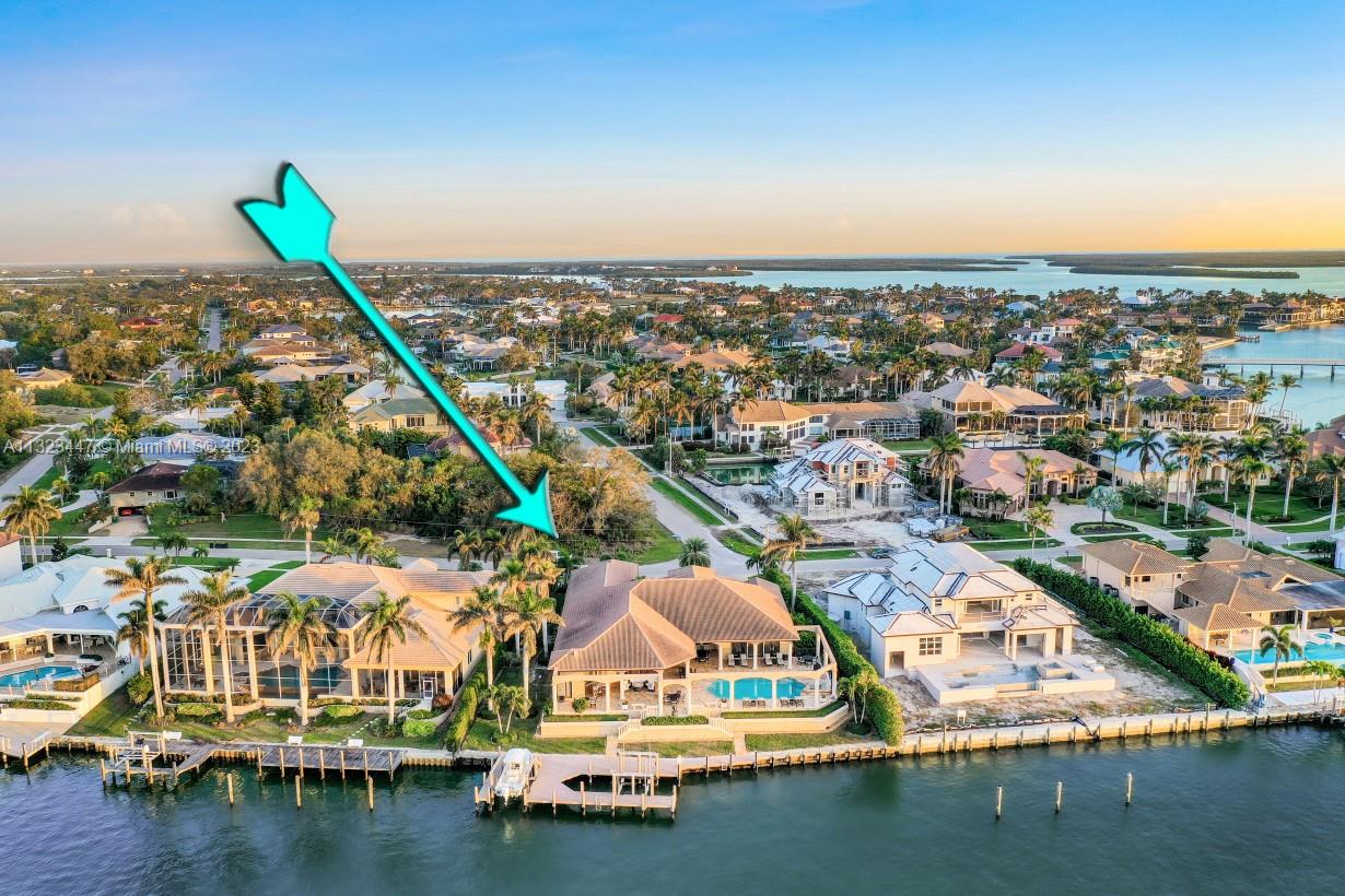 The absolute second of stepping through the front doors of this stunning home, expansive water views take over.  While this is a five-bedroom home, the owners have added a ‘kids bunk bed & play room’ to one of the dens and added a queen-sized bed to the other den to comfortably accommodate more guests.  The Gulf of Mexico is just minutes away and if there is an avid fisherman, there is both backwater fishing and offshore fishing boating access from one of your TWO direct-water lifts.  With over 150 feet of waterfront there is plenty of room for any type of vessel you want to park behind this ranch-style home.  Huge pool, WESTERN EXPOSURE for SUNSETS!!!  GOURMET KITCHEN with gas and Viking appliances, 2 dishwashers, wet bar and just too much to list.