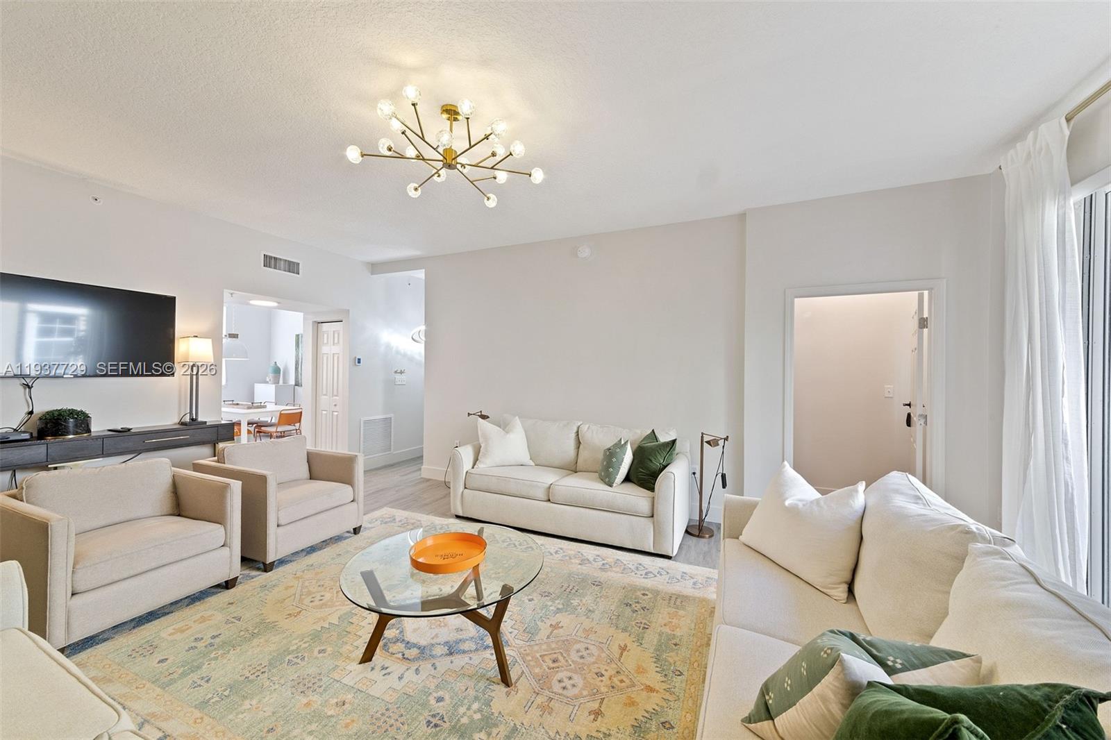 Rare Opportunity in the Heart of Hallandale Beach! Just minutes from the famous Hollywood Boardwalk and Aventura Mall. This 3-bedroom, 3-bath residence includes a 2-car garage with a screened garage door, epoxy flooring and guest parking, plus a newer A/C system.  Designer interiors with three fully renovated suites, open-concept living, a dedicated laundry room, and upgraded features throughout. All assessments have been fully paid. Beyond safety and tranquility, the property offers private beach access with four chairs and an umbrella, two pools, a hot tub, barbecue areas for both the main building and the townhomes, canal access, and an ocean-view gym.  Experience luxury coastal living in South Florida, just moments from shopping, dining, airports and entertainment. Located in a community that allows short-term rentals (30-day min) — perfect for investors or seasonal living.