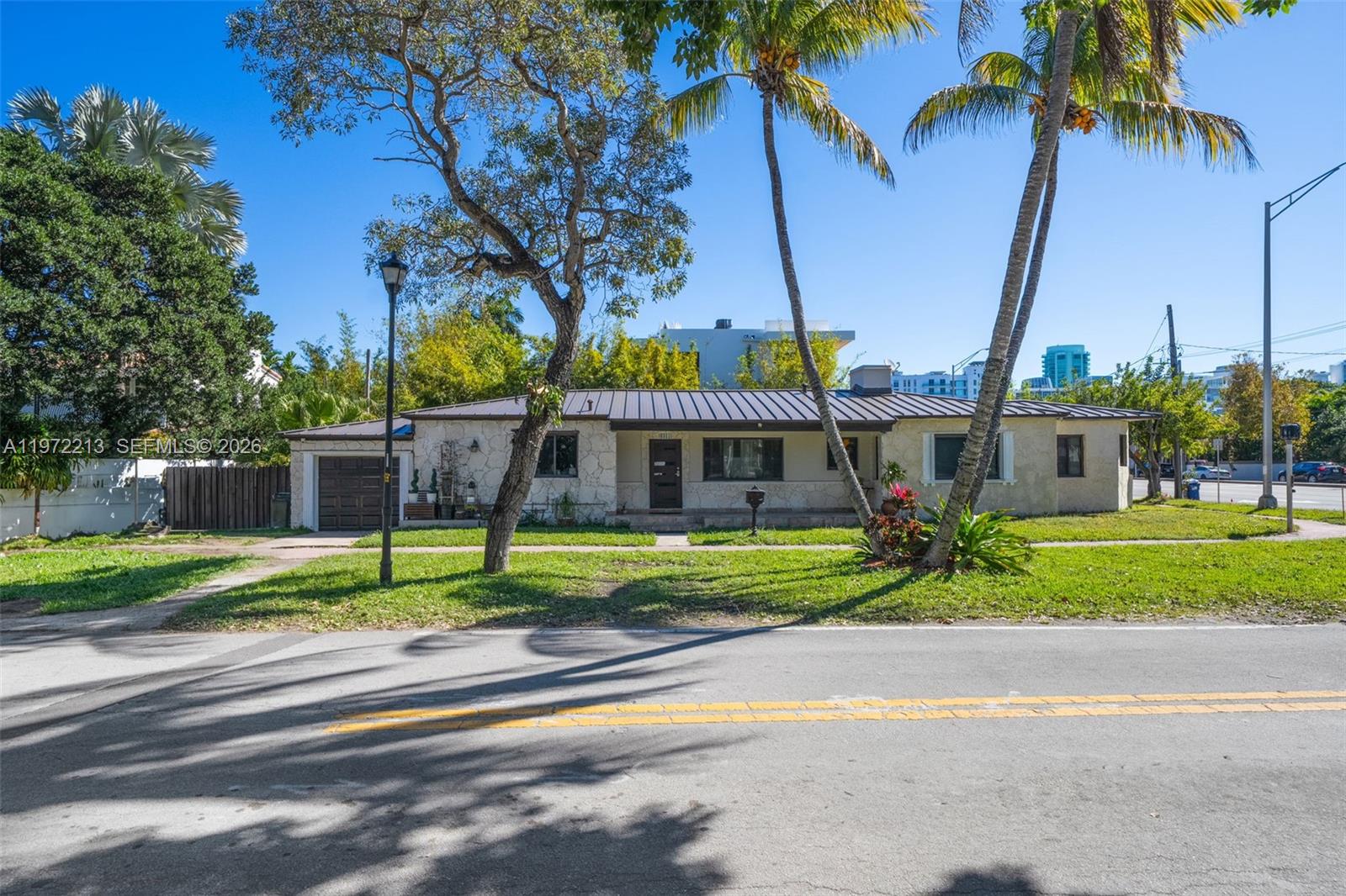 Positioned in the heart of the highly sought-after La Gorce neighborhood, this address places you less than a 10-minute walk to the beach while tucked away in a quiet residential enclave. Moments from La Gorce Country Club and surrounded by multi-million-dollar waterfront estates, the location delivers both prestige and long-term value. The existing 3-bedroom, 3-bath residence sits on a 5,720 square foot corner lot and features a 2021 roof, two 2020 A/C systems, a renovated kitchen, city gas service, gas water heating, and a one-car garage. Comfortable to enjoy as-is, it also offers clear potential for thoughtful renovation or expansion. Whether held as a strategic investment, enhanced to suit your vision, or reimagined among surrounding luxury homes, the appeal lies in flexibility within a blue-chip neighborhood. Enjoy convenient access to Bal Harbour Shops, Sunset Harbour, South Beach, golf, boating, and the beach path, all while maintaining the privacy of a residential setting. An attractive entry point relative to surrounding new construction, 6311 La Gorce Drive represents long-term positioning in one of Miami Beach’s most consistently coveted addresses.