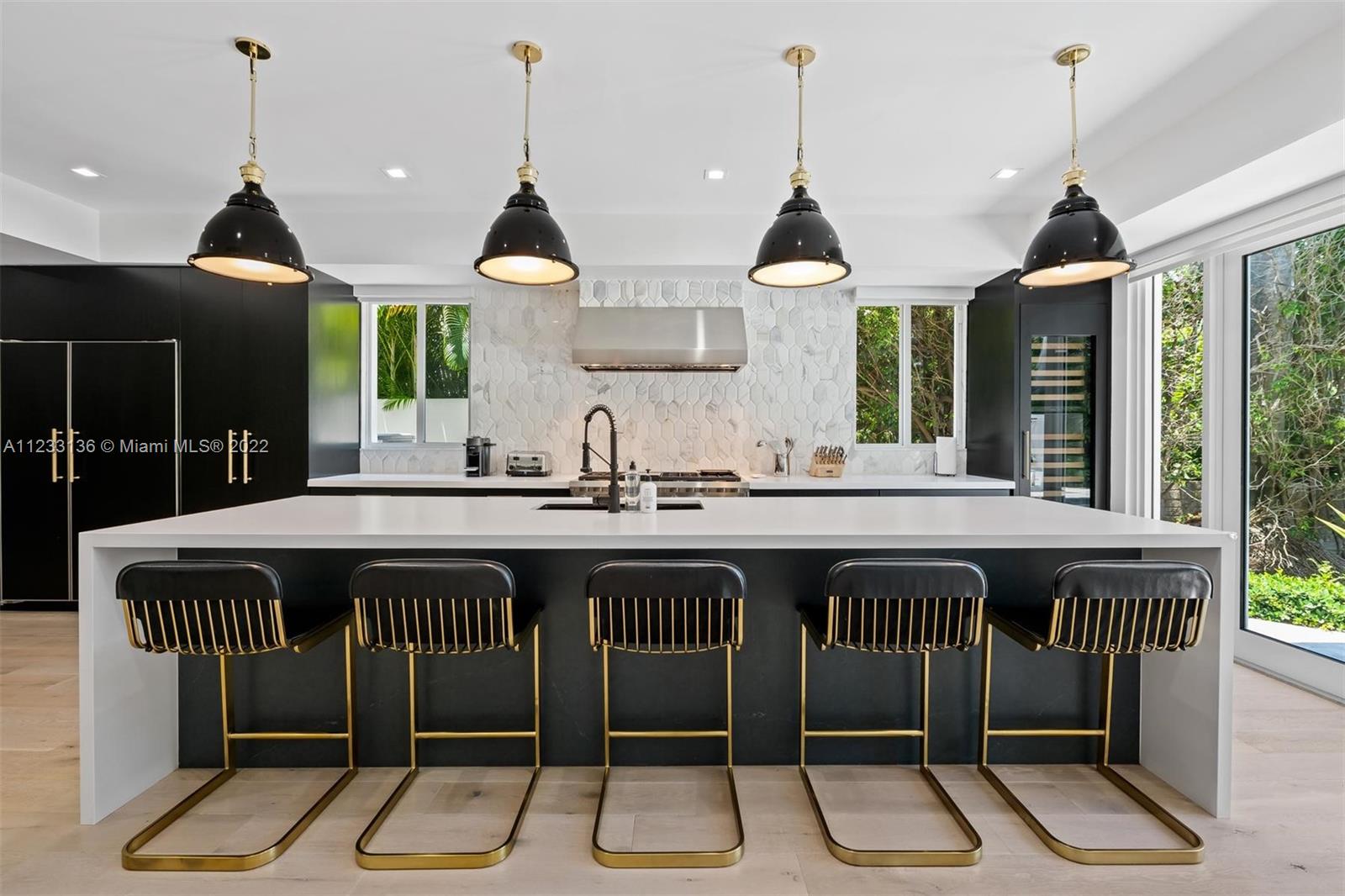 Luxuriously renovated, lushly landscaped 2 story retreat on coveted North Bay Rd. Live large in the spacious open plan main floor, w/ floor-to-ceiling windows offering views of the inviting backyard pool. Striking black & white accents accentuate the home's modern vibe. The black fireplace anchors the sleek living room, while black beams define the dining space. The motif continues in the stunning kitchen, w/ a massive white island, black cabinets & high-end appliances. A cozy family room leads to the laundry & garage entrance. The beautiful primary suite includes a sitting area, an immense closet & a spacious en-suite bathroom w/ a soaking tub, tiled shower & dual sink vanity. The home can also be sold fully furnished and professionally decorated.