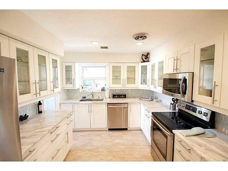 Your dream house awaits. Professionally rebuilt from the ground up. Great chef's kitchen with outside exhaust. Bathrooms appointed w marble shower surrounds & marble floors. All windows & doors are hurricane IMPACT, adding safety. Large fenced yard. Great  neighborhood with A schools. GAS & electric utilities! Extra wide door ways for wheelchair access. Everything is new, from all electric to gas water heater and landscaping. Large air conditioned utility room with new front loaders.
