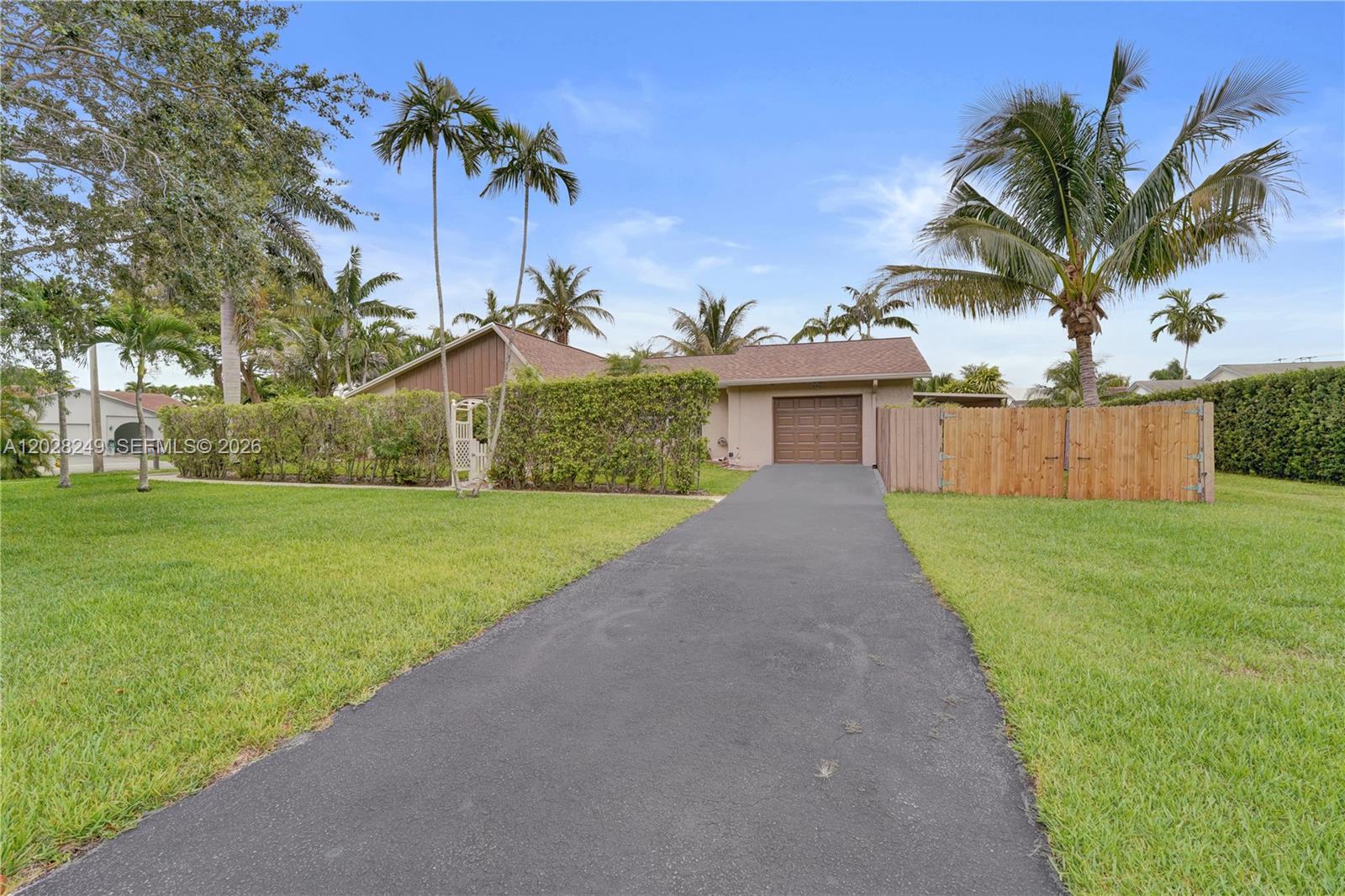 Enjoy South Florida living at this beautifully updated 3-bedroom, 2-bath home which has all the major improvements already completed, including a new 2025 roof, impact windows and doors, and a 2024 A/C system.
Inside, dramatic vaulted ceilings and a freshly painted crisp white interior create a bright, open, and inviting atmosphere. The flexible Family Room, equipped with its own separate A/C, is ideal as a home office, media room, guest suite, gym, or creative space.
Situated on a wide corner lot adjacent to a peaceful linear park, this property offers added privacy and room to spread out. Oversized garage provides valuable space for car, storage, or workshop. Smart-home features add convenience and security.
Screened patio and large fenced backyard with plenty of room for a pool. The side yard offers plenty of space for boat or RV parking, while the newly installed double gate provides added privacy and security.
Perfectly located just 1.1 miles from the beach, 2 miles from Fort Lauderdale-Hollywood International Airport, and minutes from Dania Pointe, shopping, dining, entertainment, parks, and nature preserves. Whether you're looking for a primary residence, vacation home, or investment property, this home combines location, flexibility, and major value in one exceptional price.