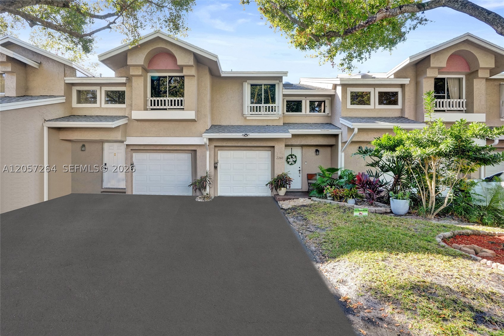 Beautifully updated 2-bedroom, 2.5-bath townhouse situated on a large lot with mature trees, just steps from the pool, tennis and pickleball courts, and clubhouse in the highly sought-after Discovery Pointe community. Quiet interior location in the community. Gated community with night-time security. Dog friendly community. This lovely home features a desirable split floor plan and numerous upgrades, including a new A/C unit, impact garage door, upgraded attic insulation for improved energy efficiency, new light fixtures and faucets, new screening on back porch, a stylish barn door in the primary bedroom, redesigned kitchen with a new stove, new ceiling fans, and new carpet on the stairs. Additional updates include a new roof, new gutters, and a new water heater. The home offers a spacious living room and a formal dining area. The kitchen showcases beautiful off-white cabinetry, generous countertop space, a stylish tile backsplash, and stainless-steel appliances. The spacious primary bedroom features an updated en-suite bathroom and a walk-in closet with custom cabinetry. The second bedroom is also en-suite with a large closet. Enjoy year-round outdoor living on the large, tiled, screened-in patio overlooking a beautiful lake view.