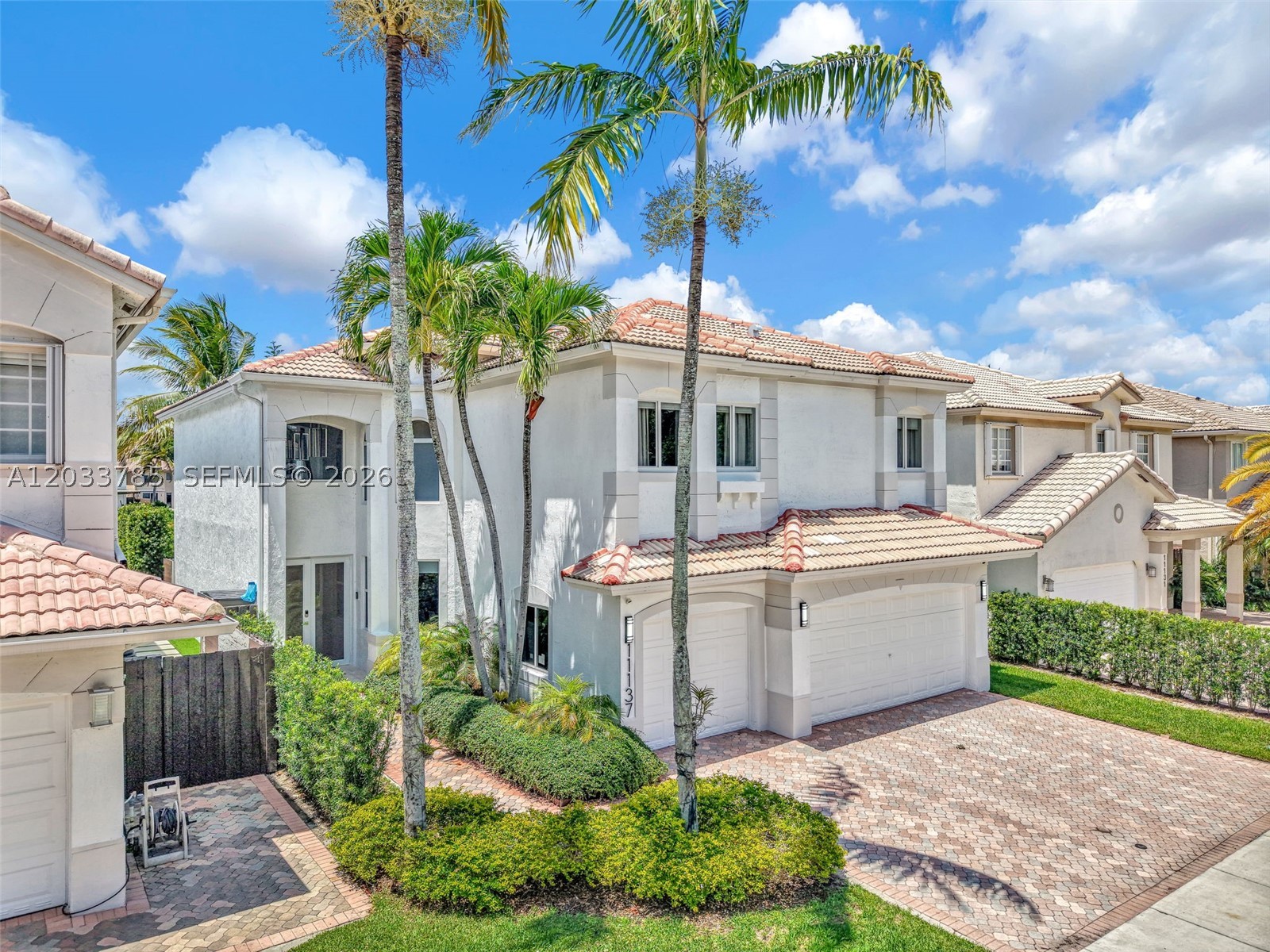 Beautifully remodeled lakefront residence in the highly sought-after Doral Isles community! Offering 3,050 SF of living area, this exceptional home was extensively renovated  with high-end finishes and upgrades . Features include 5 bedrooms and 3 full bathrooms, with one bedroom and one full bath conveniently located on the first floor.

The custom-designed kitchen showcases premium cabinetry, modern finishes, and elegant lighting. Additional upgrades include impact windows and doors, a high-end impact front door, electric shades, integrated ceiling speakers, designer lighting throughout, smooth-finish walls, custom built-in . The entryway was redesigned to create a seamless, step-free entrance, enhancing both functionality and aesthetics.

The exterior has been freshly painted, and the home offers beautiful lake views from its spacious living areas. The roof is original and has been well maintained with no known issues. Located in one of Doral’s premier gated communities with resort-style amenities, top-rated schools, parks, and convenient access to shopping, dining, and major highways.

Move-in ready and meticulously updated,this is a rare opportunity to own a turnkey waterfront home in Doral Isles.