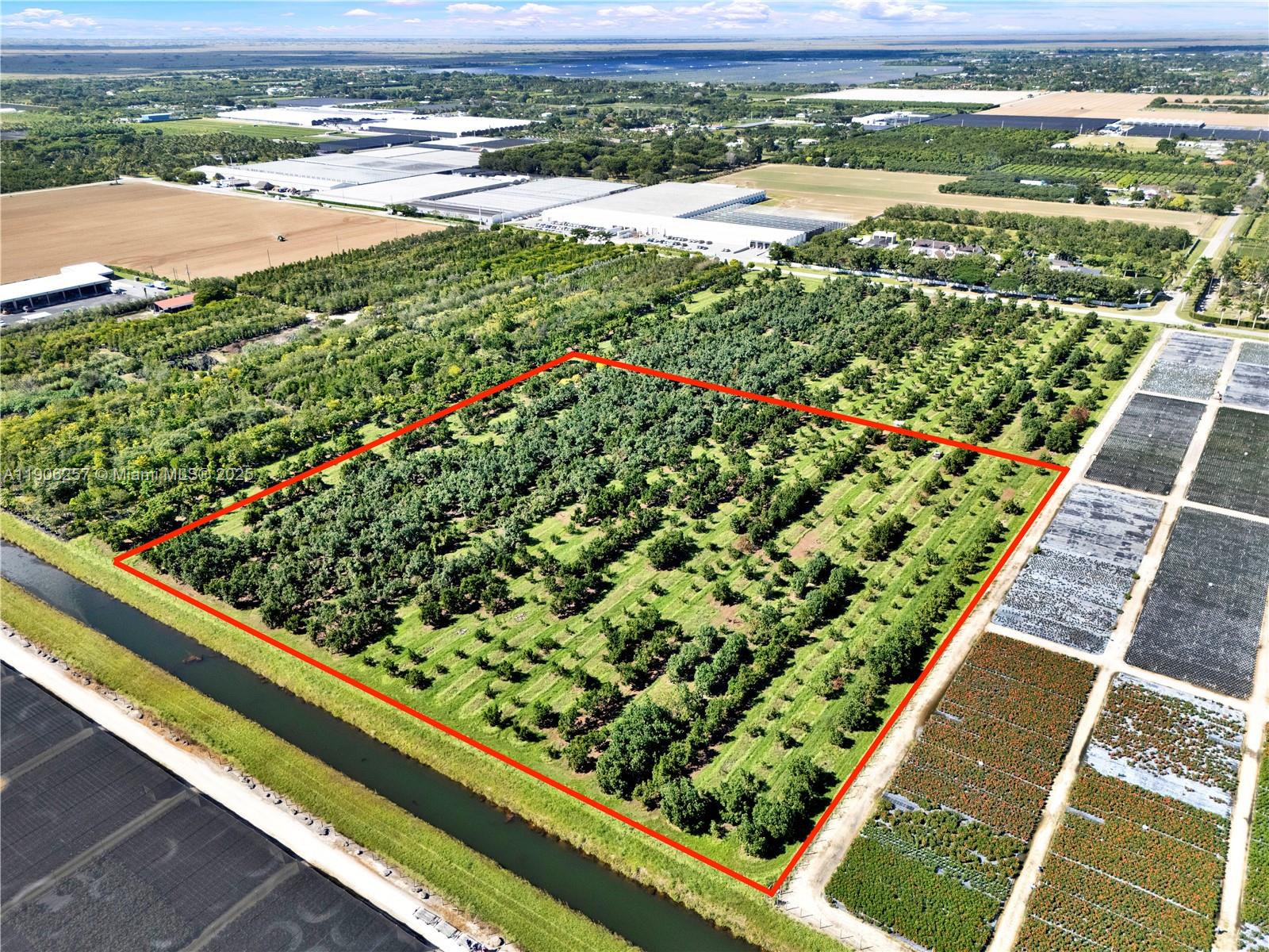 Owner financing is available on favorable terms.
This canal-front avocado grove spans 8.81 acres in South Dade’s agricultural zone. The property includes a full sprinkler irrigation system, complete fencing, and direct canal access, making it suitable for agricultural use, investment, or a private estate. Mature avocado trees are well maintained, and the infrastructure supports both production and residential potential. This is a rare opportunity offering both canal frontage and grove income. The property may be sold with folio 30-6833-000-0031, providing a combined total of 13.9 acres. A recorded 20-foot-wide easement provides access from 264th St.