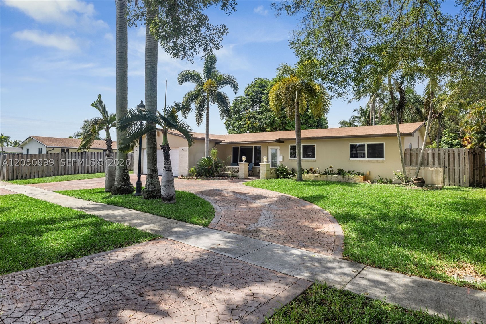 Spacious 5 bedroom, 3 bathroom home in Pembroke Pines located within walking distance of Pasadena Lakes Elementary. This property offers excellent curb appeal with three tall palm trees lining the driveway, terrazzo floors, updated kitchen with granite countertops, stainless steel appliances, and a sliding kitchen pass-through window ideal for outdoor entertaining. Large backyard offers room to potentially build a pool, and the cabana bathroom with exterior access is perfect for guests and future pool use. Flexible private bedroom suite includes oversized bathroom, private entrance, and kitchen access, offering great potential for extended household living or possible roommate income. The layout is ideal for entertaining, multi-generational living, or buyers needing extra privacy and flexibility. Enjoy South Florida living with a spacious yard, covered patio area, and easy access to nearby schools, parks, shopping, dining, and major roadways. Qualified buyers may be able to purchase with as little as 3% down. Buyer may also receive a free appraisal and 1-year home warranty when using seller’s preferred lender, subject to terms and conditions. A great opportunity in the heart of Pembroke Pines!