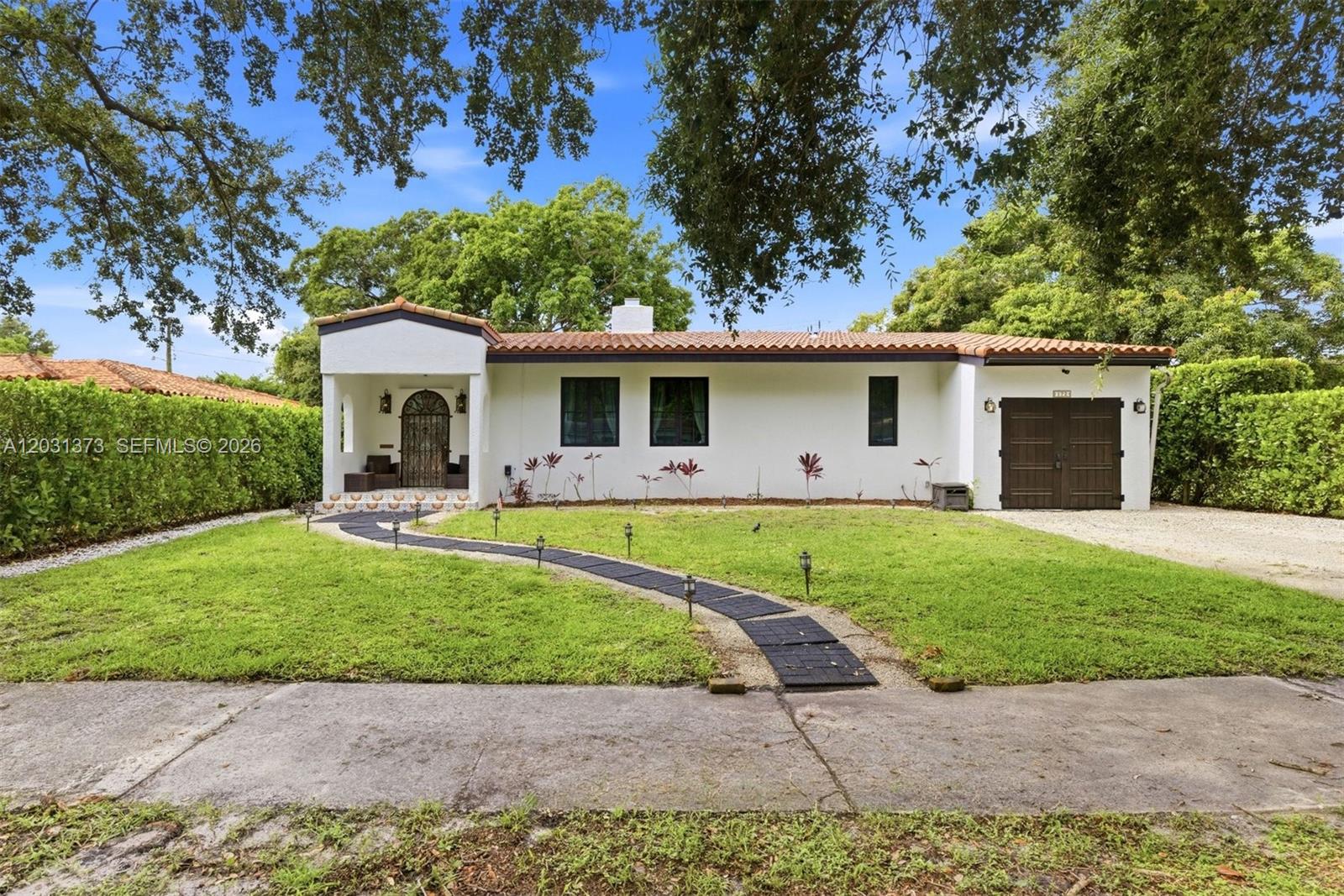 Discover the perfect blend of tranquility and character in this beautifully appointed residence nestled in the storied enclave of El Portal. This home offers a unique opportunity to own a piece of one of Miami-Dade’s most cherished neighborhoods.
From the moment you arrive, you’ll be struck by the lush, mature landscaping that defines the El Portal experience—a vibrant, green oasis that feels worlds away, yet remains moments from the pulse of the city. This home has been thoughtfully maintained, featuring 3 bedrooms, 2 full bathrooms, original oak flooring, vaulted living room ceiling, along with many other Mediterranean details that make it an absolute charmer.
Situated in a tranquil pocket that balances peace and quiet with quick, easy access to the best of Miami’s cultural, dining, and shopping destinations. A rare find that is perfect as-is, but offers the flexibility to tailor the space to your personal vision.