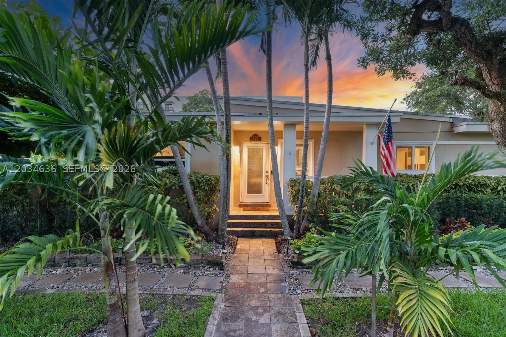 Step into a life you've always imagined. This beautifully updated Mid-Century Modern pool home in North Miami isn't just a place to live — it's a lifestyle upgrade waiting to happen.
From the moment you walk through the door, you'll feel it. Soaring exposed beam ceilings draw your eyes upward while transom windows bathe every room in warm, natural light. Open, airy spaces invite you to breathe deep and settle in — this home simply feels right. The heart of the home delivers in every way, with granite countertops, stainless steel appliances, and a breakfast bar perfect for morning coffee or entertaining friends. The oversized bathroom feels like a personal retreat, featuring dual vanities and a large enclosed shower — because your daily routine deserves a little luxury. 
Out back, paradise is waiting. Take a dip in the heated pool, fire up the covered outdoor kitchen, and enjoy everything Florida living was meant to be. A privacy hedge, mature palms and fruit trees, and a fully fenced yard create a serene, tropical escape — while the electric gate lets you pull in and park securely behind the fence. A large covered flex space gives you endless options for garaging, hobbies, or storage.
Inside and out, the smart touches make all the difference — barn doors, built-in cabinetry, a newer roof, and impact windows give you both style and peace of mind.
This is more than a home. It's your next chapter.