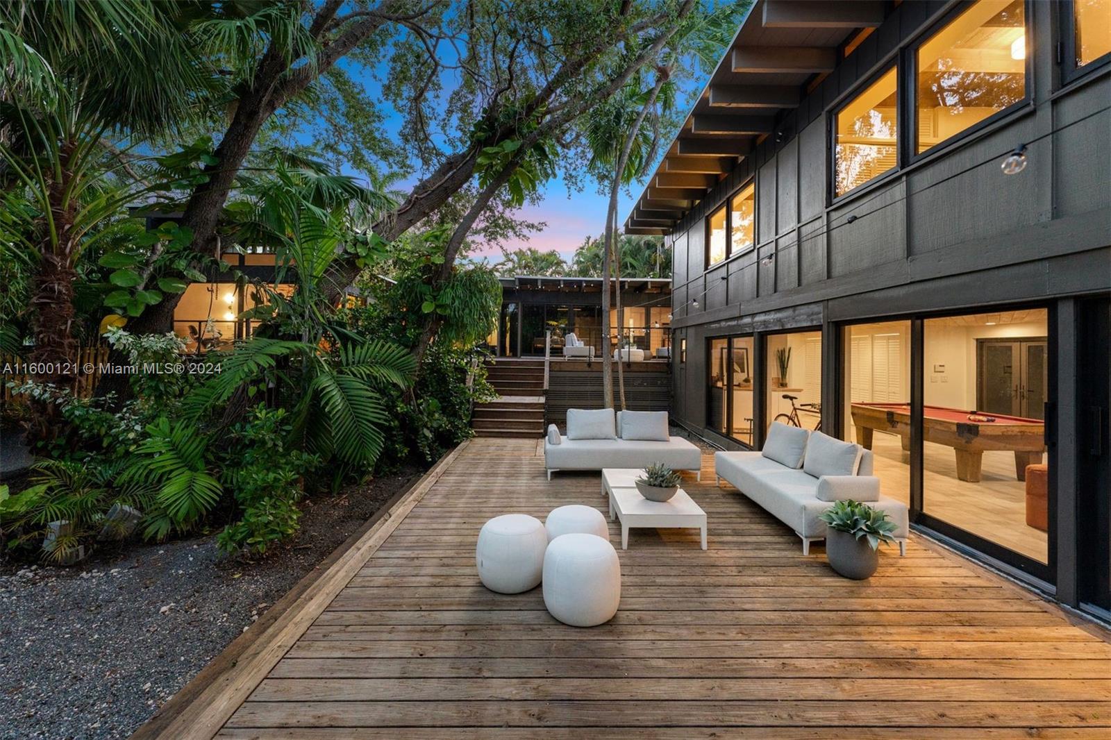 Architecturally significant Coconut Grove masterpiece crafted by renowned architect, Peter Jefferson. Tri-level 4/3 remarkable home on 10,400 sf private lot w/over 3k sf liv area & 1k sf of deck space. Updated baths, solid wood floors, full impact glass, custom designed kitchen, state-of-the-art appliances & quartz countertops. Generous walls of glass & wood beam ceilings create a naturally lit zen-like tree-house effect seamlessly merging interior to nature w/tropical garden views from every room. Recreation room opens to fenced front yard & huge deck. $1mil in 2022 updates & 2024 refurbished roof. Pool/spa renderings avail to build your own new pool. Generator. Desirable Battersea in SE Grove-best dining, shopping, entertainment, waterfront parks, yacht clubs, top rated schools.