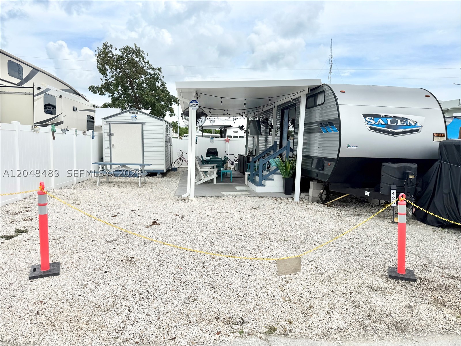 Discover the perfect blend of comfort, investment potential, and the Florida Keys lifestyle with this fully furnished 2021 Forest River Salem 2-bedroom trailer in the highly desirable Calusa Campground, Key Largo. Designed for relaxation and entertaining, this property features a permitted PVC privacy fence, an aluminum pergola with slide-out covers, an outdoor TV, oscillating fans, and upgraded electrical outlets throughout the outdoor living space.
The detached insulated shed offers exceptional versatility with a second kitchen, storage area, nautical décor, new A/C, and its own electrical panel. Additional highlights include a second full bathroom, outdoor shower, and a fully equipped outdoor kitchen with a stainless-steel 4-burner gas grill and prep station—perfect for enjoying the Keys year-round.
Located in a short-term rental-friendly community, this property offers excellent income-producing potential or the ideal personal vacation retreat. Don't miss this unique opportunity to own your own slice of paradise in Key Largo—schedule your private showing today!