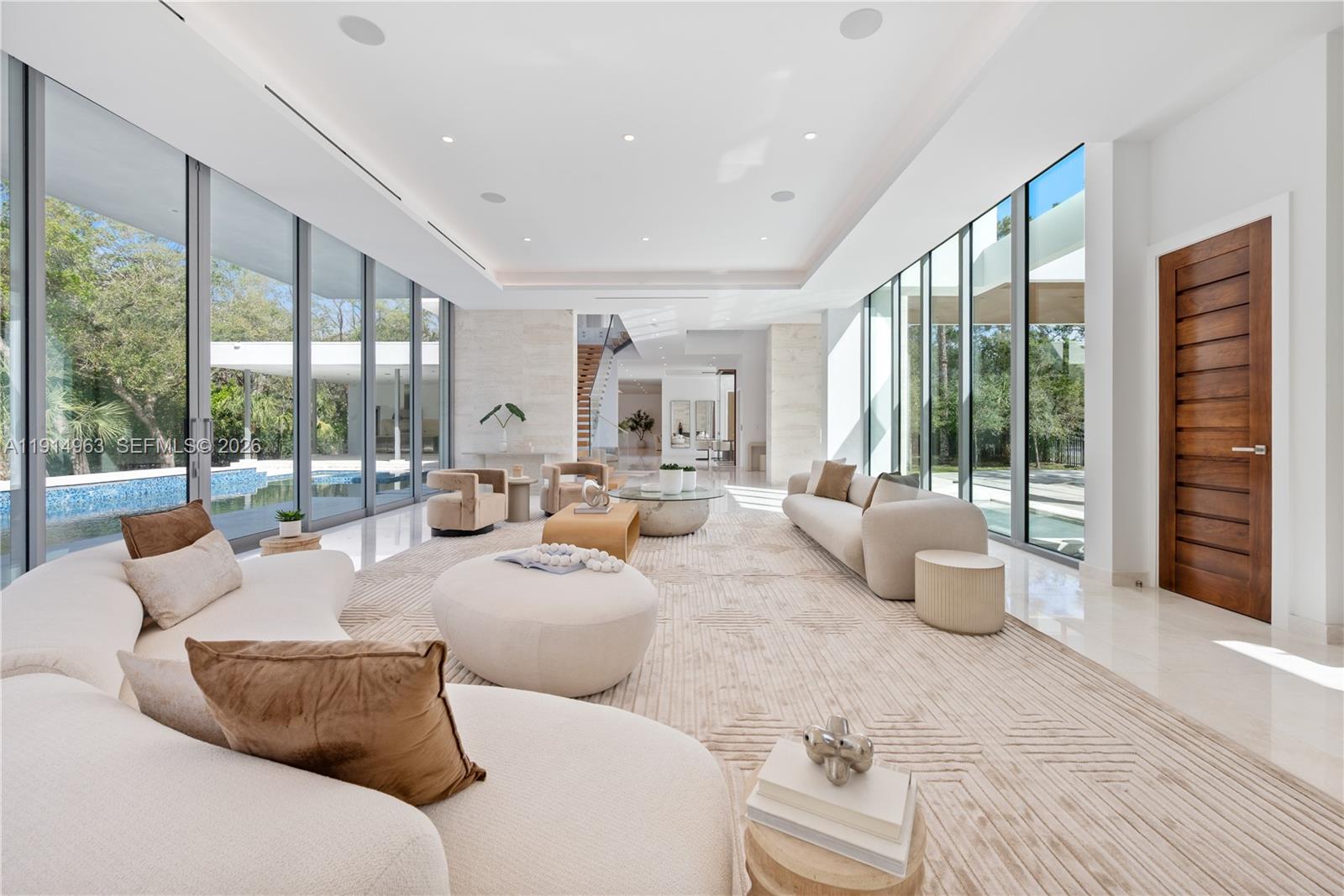 Villa Acqua di Gioia in the heart of North Pinecrest, blends modern sophistication with serene privacy on a prime corner lot. This 11,255 SqFt home includes 7 bedrooms and 7.5 baths, featuring soaring ceilings and retractable 12-foot sliding glass windows for seamless indoor-outdoor living. Designed by Balli Architecture, it boasts luxurious amenities, including a resort-style pool, infinity edge jacuzzi, elevator, a spacious 3 car garage and marble floors throughout.  A media room provides entertainment, while a standalone gym or in-law quarters with a private bathroom offers added convenience. Culinary enthusiasts will love the Italian kitchen by Pedini with a gas stove and high-end appliances. With 2 independent entries, this estate epitomizes luxury living in a tranquil setting.