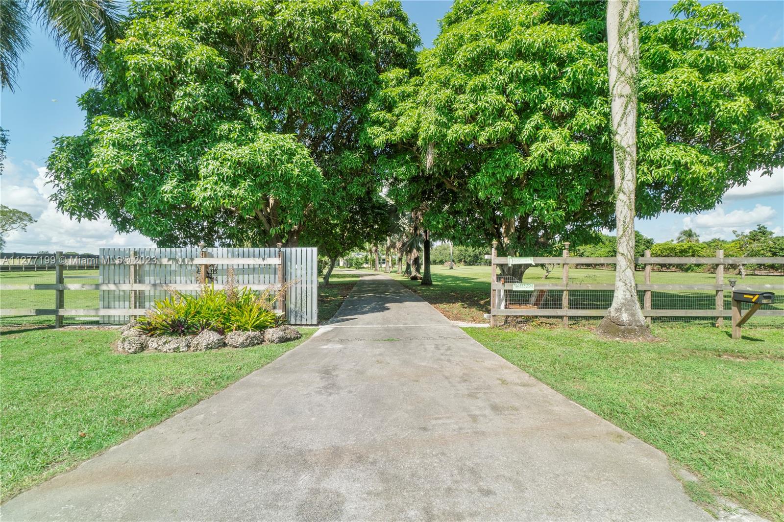 MUST SEE THIS AMAZING PEACEFUL property located on 4.73 acers in Homestead to appreciate all it has to offer.   Quaint farmhouse with spectacular entrance, new roof, impact windows, large kitchen with window looking out onto the property. Many water wells located throughout the property.  Horse stables that can bring income or can be used to store vintage cars.  Income producing exotic trees such as Jack Fruit tree, Curry tree, Old Spice tree, Mamey tree and more.   Additionally, a separate guest/in law quarters that can be used for income.  Must see in person to appreciate all the beauty of this property.  Make this your home! Great place to raise a family, create an event venue or a new development. BY APPOINTMENT ONLY.