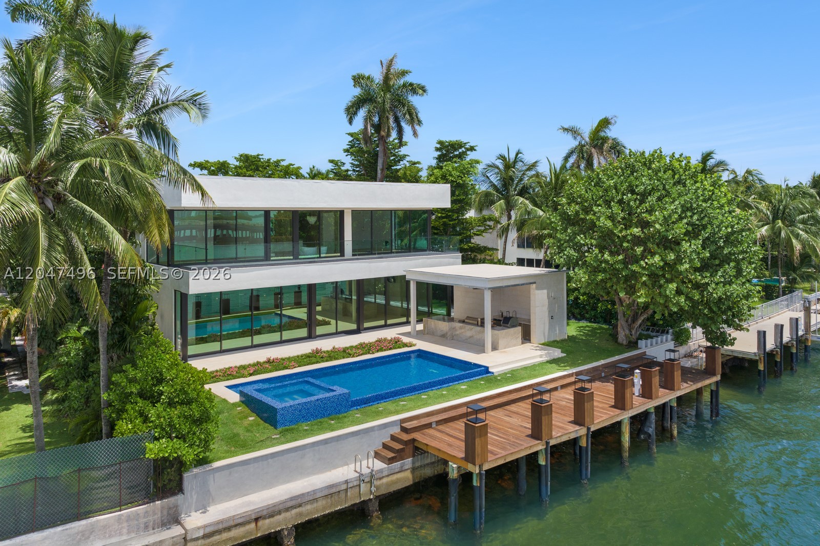 Presenting a spectacular brand-new waterfront estate. THE LARGEST HOME EVER BUILT IN BAY HARBOR! Offering
10,450 SF of ultra-luxury living with panoramic open-bay views, this masterpiece sits on 83 feet of prime
waterfront with direct ocean access, private dock, boat lift, and breathtaking sunsets. The estate features 7
spacious en-suite bedrooms, a private cinema, an office & library. The chef’s kitchen with double islands flows into
a dramatic 30-foot dining room ceiling, complemented by a wine cellar, elevator, smart-home technology, and
luxury finishes throughout. Outdoor living boasts an infinity mosaic-glass pool with Jacuzzi and spa, a full outdoor
kitchen, cabana, sauna, and a 2,000 SF rooftop deck - delivering the ultimate resort lifestyle.