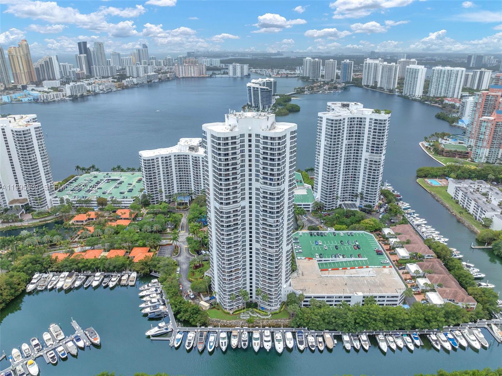 Enjoy spectacular, unobstructed views to the east, south, and west — encompassing the ocean, Intracoastal Waterway, marina, golf course, and the cities of Aventura and Sunny Isles Beach — from this beautifully remodeled, spacious corner unit featuring three bedrooms, three bathrooms, a wraparound balcony, and 1,714 sq. ft. of living space with gorgeous hardwood floors throughout. This stunning residence, located on the 30th floor, offers expansive interiors, a functional layout, and abundant natural light. The unit includes a fully equipped kitchen, comfortable living areas, and a private balcony, perfect for enjoying breathtaking sunsets.
Located in an exclusive Aventura community, the property features resort-style amenities including a pool, a fully equipped fitness center, tennis courts, 24-hour security, and a private marina. Mystic Pointe, an all-inclusive, gated community, provides an active lifestyle with eight lighted clay tennis courts, four lit Pickleball courts, paths along the bay, a playground, mini market, restaurant, salon, dog park, and marina. It is conveniently located just minutes from the Aventura Mall and nearby beaches.